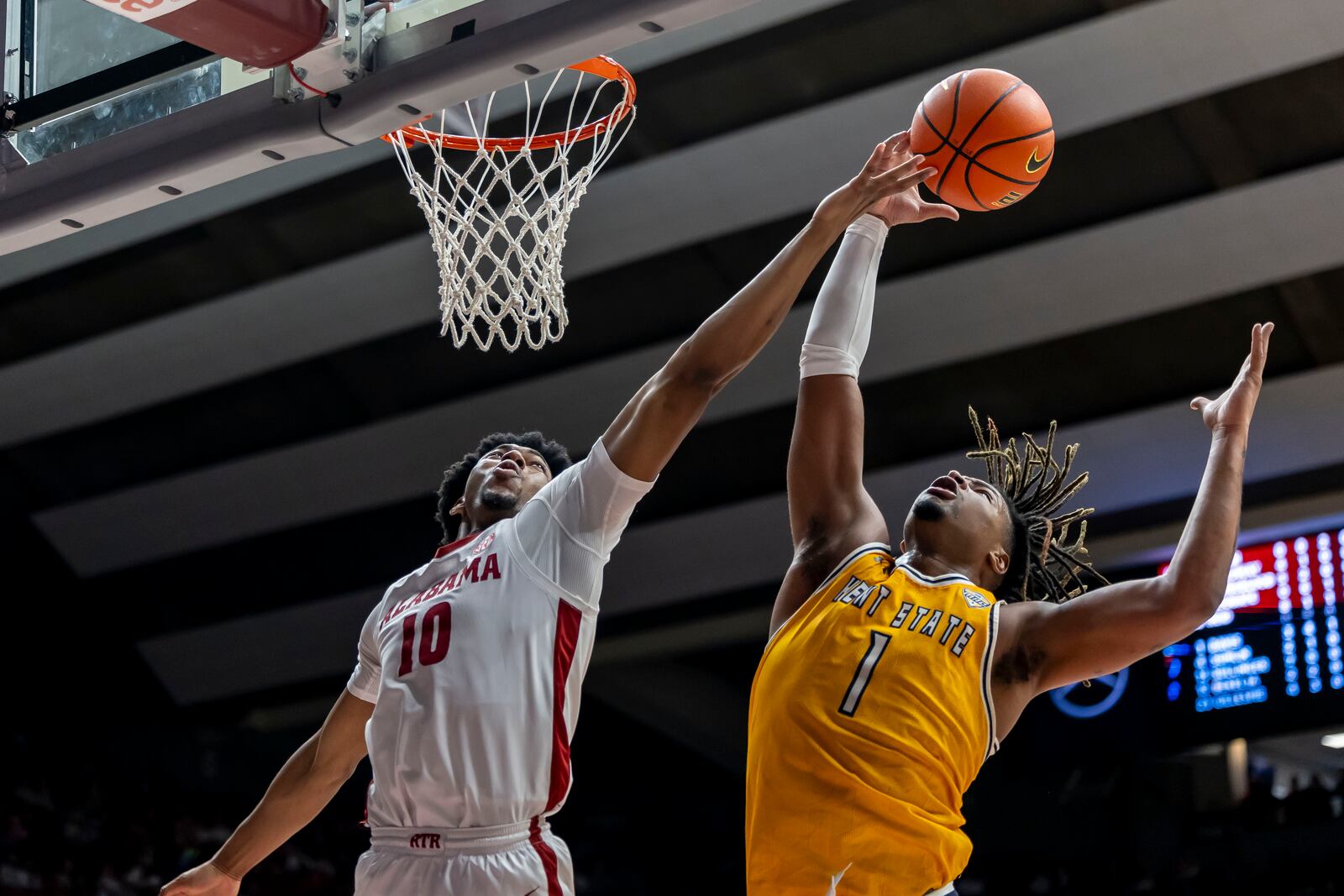 Alabama forward Mouhamed Dioubate (10) and Kent State forward VonCameron Davis (1) reach for a rebound during the first half of an NCAA college basketball game, Sunday, Dec. 22, 2024, in Tuscaloosa, Ala. (AP Photo/Vasha Hunt)