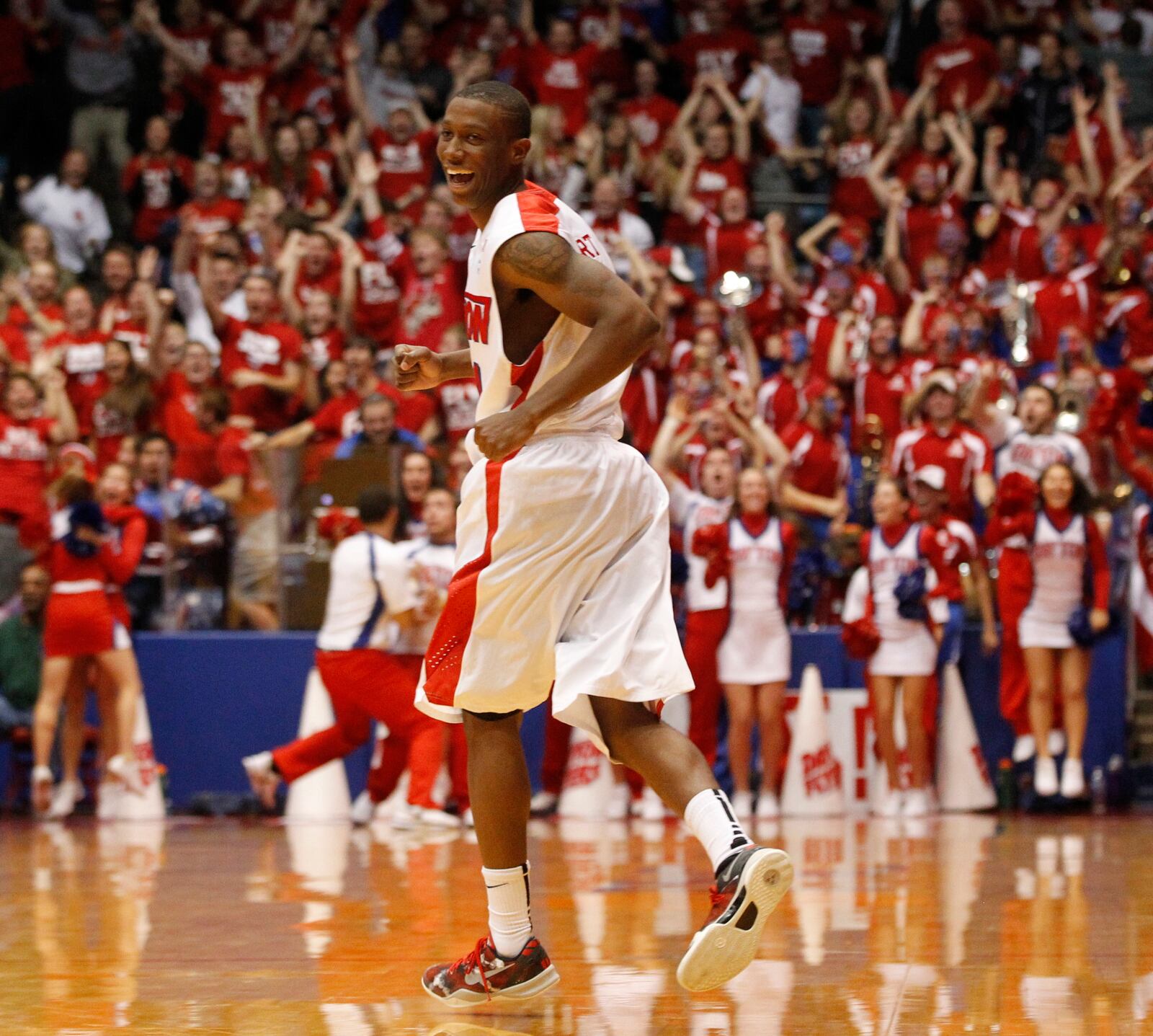 Jordan Sibert smiles as he runs back up court after a game-winning 3-pointer with 1 second left against IPFW on Saturday, Nov. 9, 2013, at UD Arena. David Jablonski/Staff