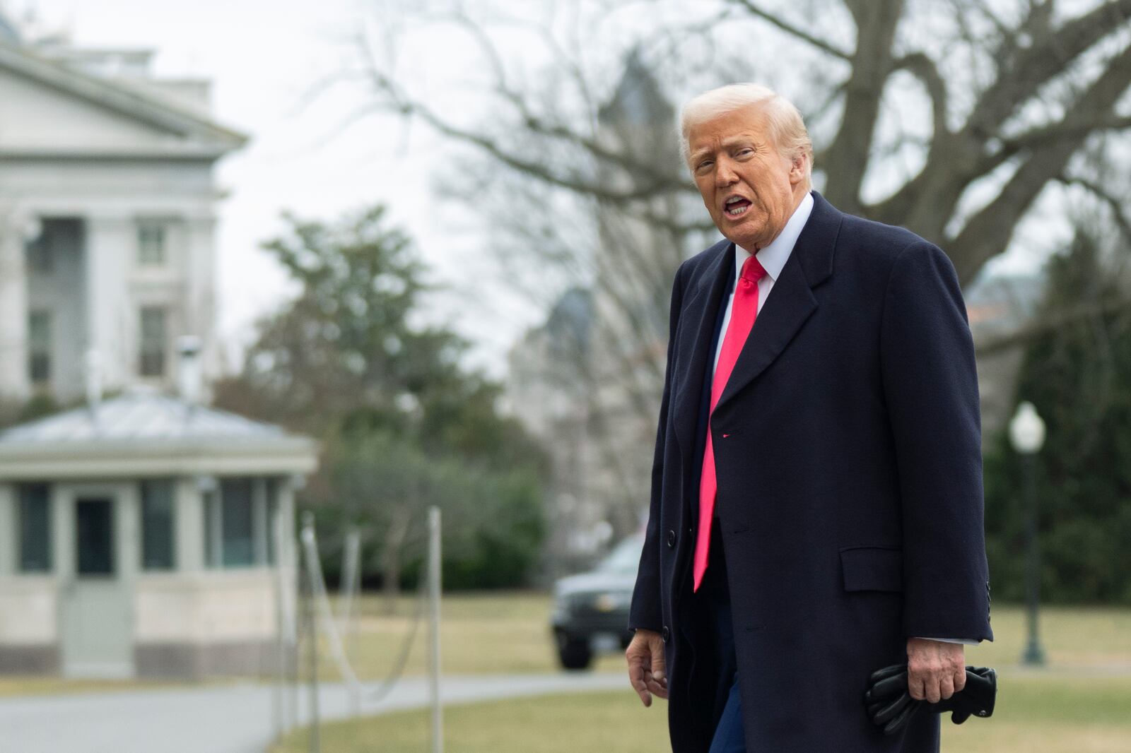 President Donald Trump responds to reporters as he walks on the South Lawn upon arrival at the White House, Saturday, Feb. 22, 2025, in Washington. (AP Photo/Manuel Balce Ceneta)