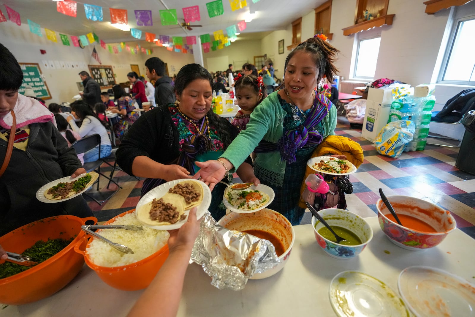 Tacos are served at the celebration of the feast day of Guatemala's Black Christ of Esquipulas at St. Mary's Catholic Church in Worthington, Minnesota, Sunday, Jan. 12, 2025. (AP Photo/Abbie Parr)