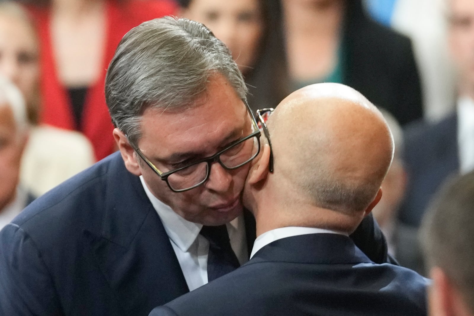 FILE - Serbian President Aleksandar Vucic, left, kisses Serbia's new Prime Minister Milos Vucevic after taking the oath during the cabinet's swearing in ceremony at the Serbian Parliament building in Belgrade, Serbia, Thursday, May 2, 2024. (AP Photo/Darko Vojinovic, File)