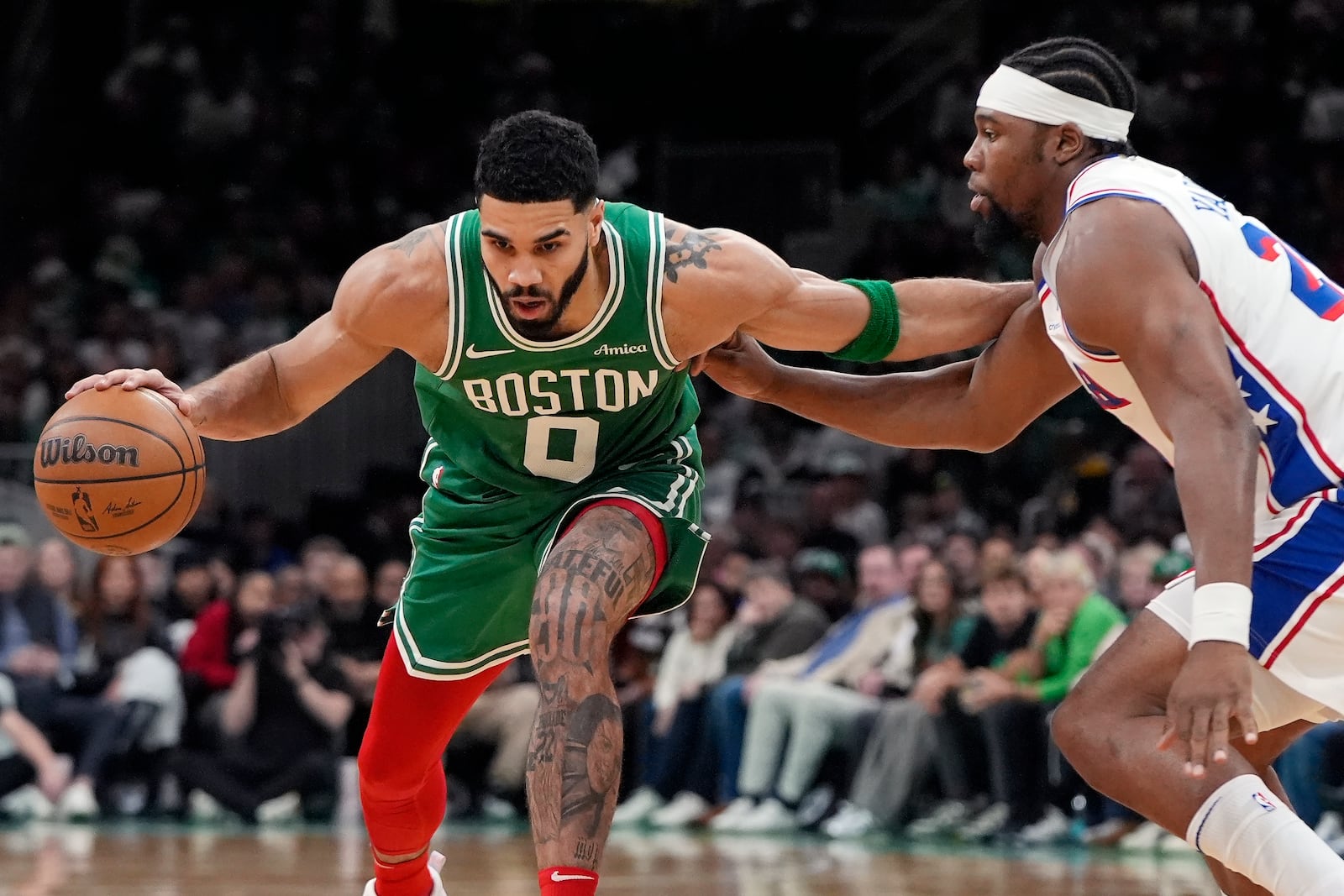 Boston Celtics' Jayson Tatum (0) drives past Philadelphia 76ers' Guerschon Yabusele during the first half of an NBA basketball game, Wednesday, Dec. 25, 2024, in Boston (AP Photo/Michael Dwyer)