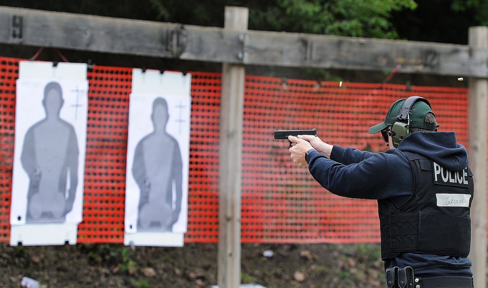 A police cadet aims at a series of targets during firearms training at Sinclair Police Academy. MARSHALL GORBY\STAFF