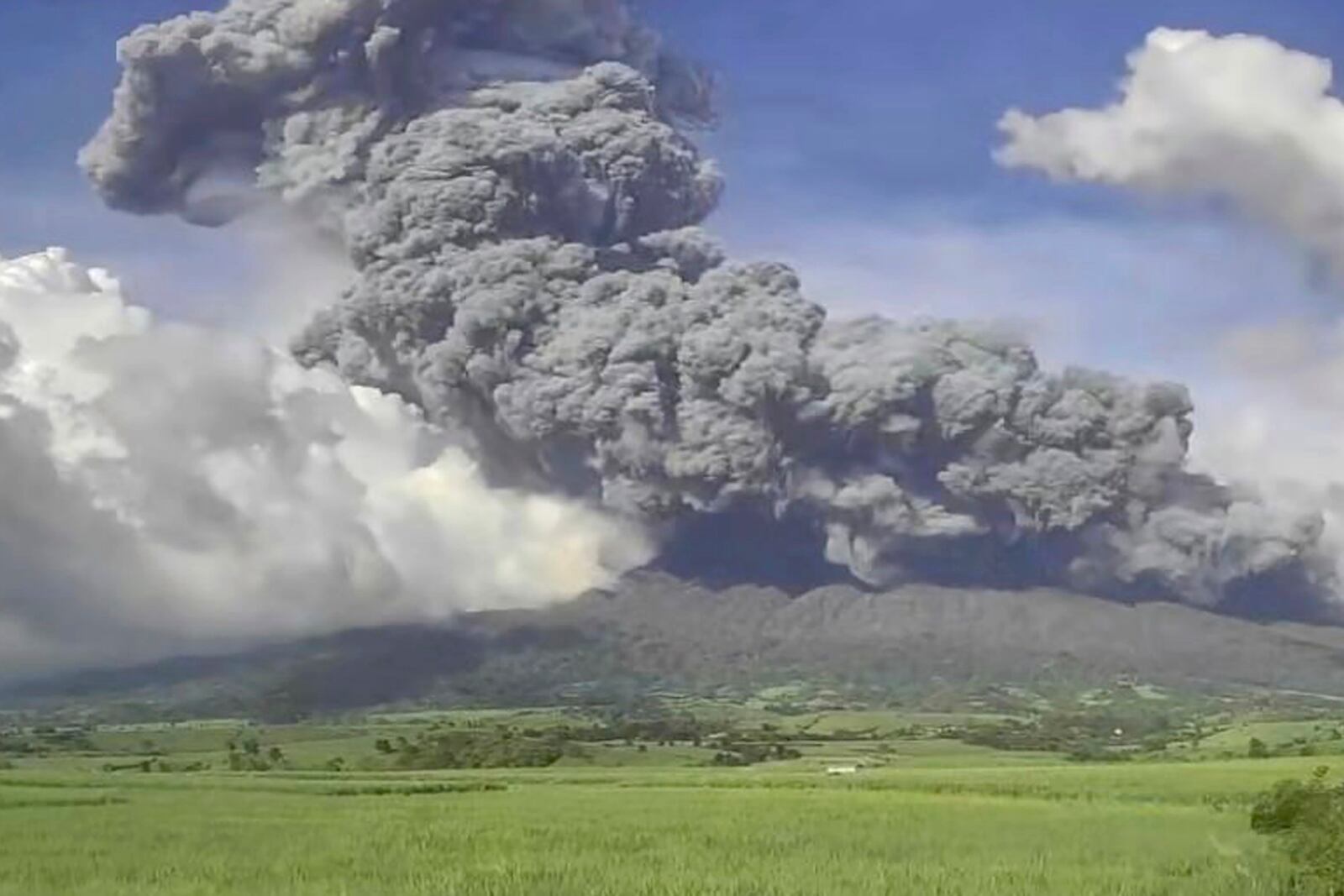 In this handout photo provided by the Philippine Institute of Volcanology and Seismology, an explosive eruption occurred at the summit vent of Kanlaon volcano, as seen from Mansalanao, Negros Occidental province, Philippines on Monday, Dec. 9, 2024. (Philippine Institute of Volcanology and Seismology via AP)