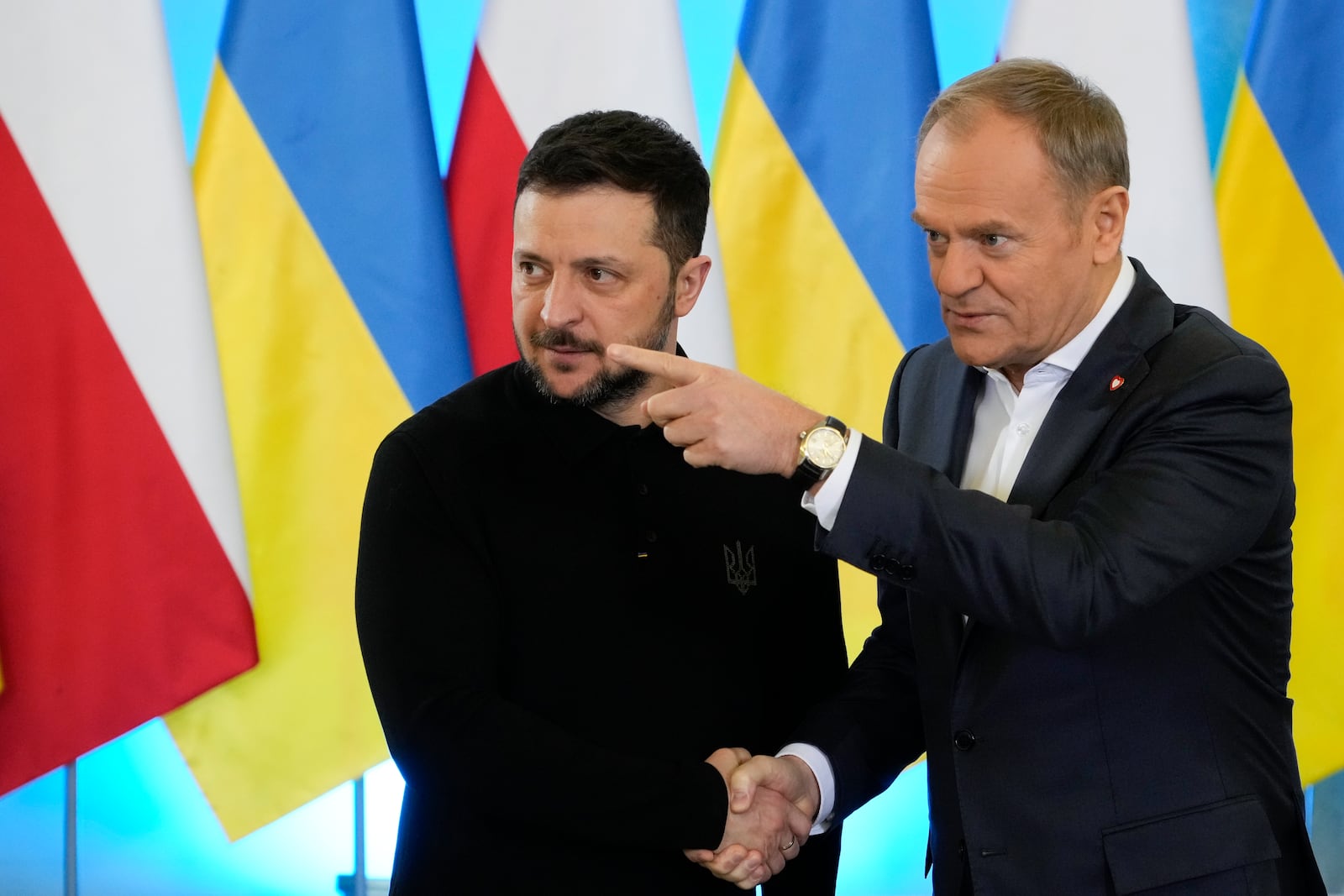 Polish Prime Minister Donald Tusk, right, welcomes Ukrainian President Volodymyr Zelenskyy after the two countries reached an agreement on a longstanding source of tensions between them: the exhumation of Polish victims of World War II-era massacres by Ukrainian nationalists, in Warsaw, Poland, on Wednesday, Jan. 15, 2025. (AP Photo/Czarek Sokolowski)