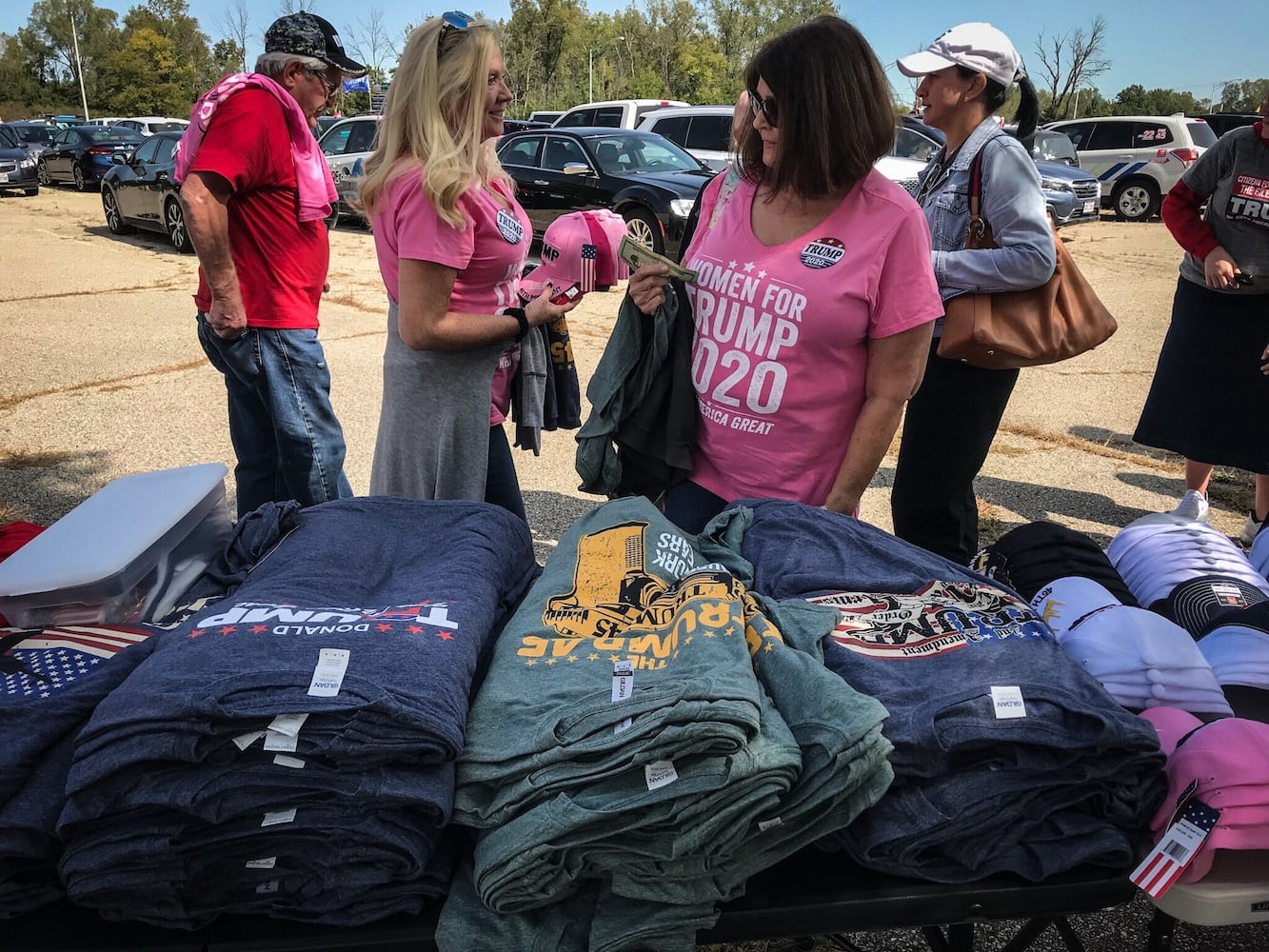 Eva Nielsen, left and Debbie Burk, both from California buy Trump swag before the rally at DIA.