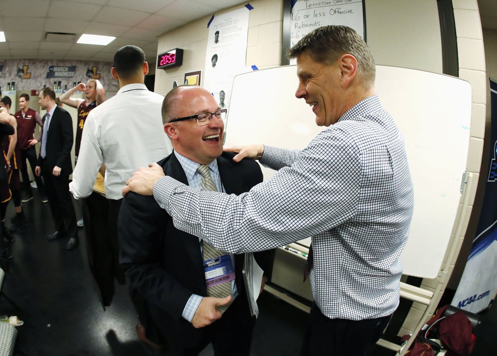 Loyola sports information director Bill Behrns, left, celebrates with Loyola coach Porter Moser after a victory against Kansas State on Saturday, March 24, 2018, in the South Regional final in Atlanta, Ga. Steve Woltmann/Loyola Athletics