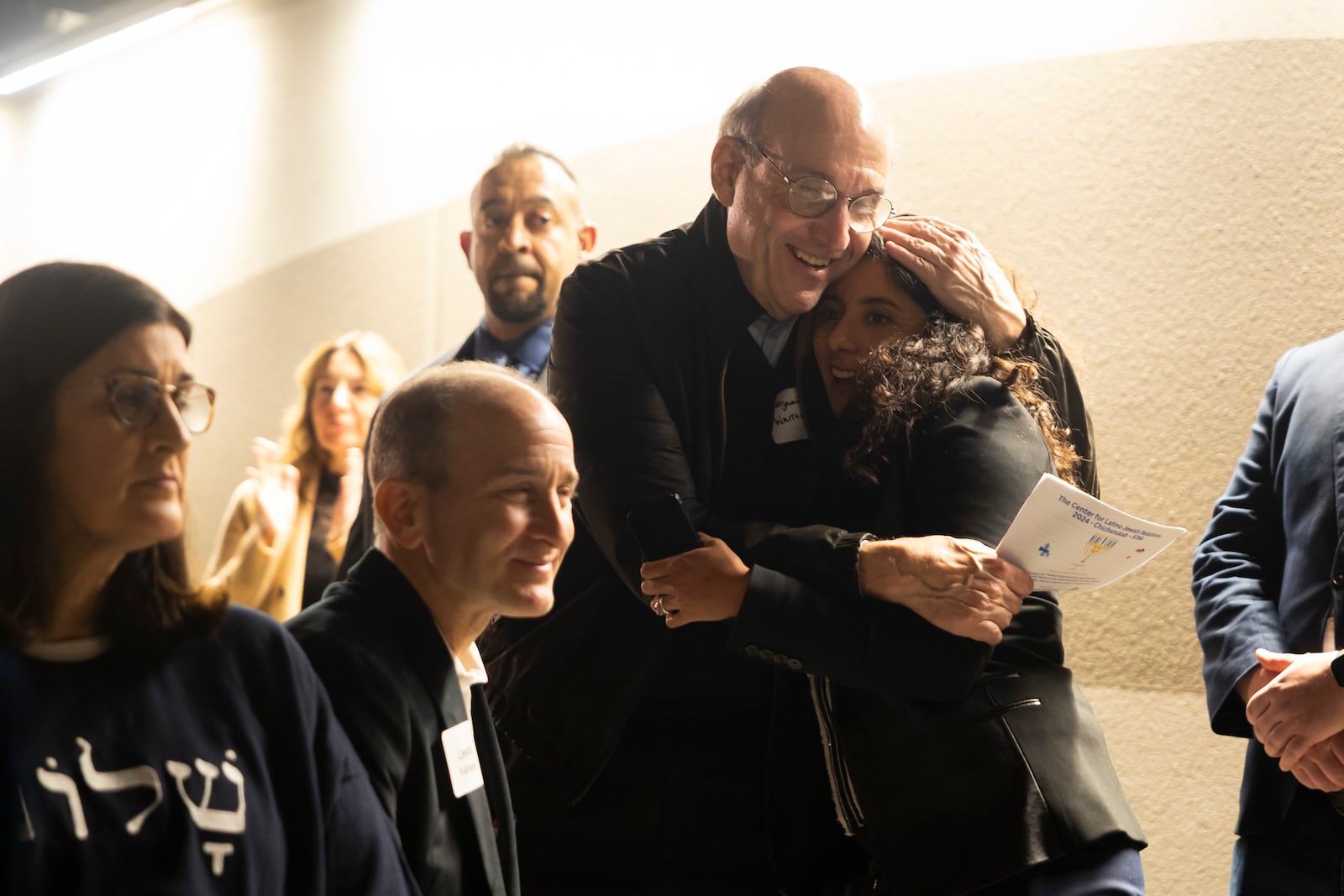 Benjamin Warren hugs Harris County Judge Lina Hidalgo after she spoke during a Chicanukah event at Holocaust Museum Houston on Thursday, December 19, 2024, in Houston. (AP Photo/Annie Mulligan)