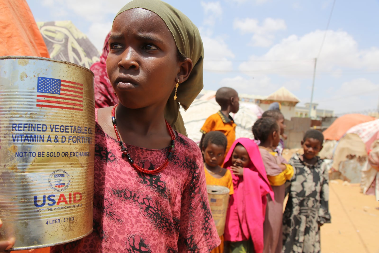 Somali internally-displaced persons (IDP) children look out from family's makeshift homes in Maslah camp on the outskirts of Mogadishu, Somalia Wednesday, Feb. 5, 2025. (AP Photo/Farah Abdi Warsameh)