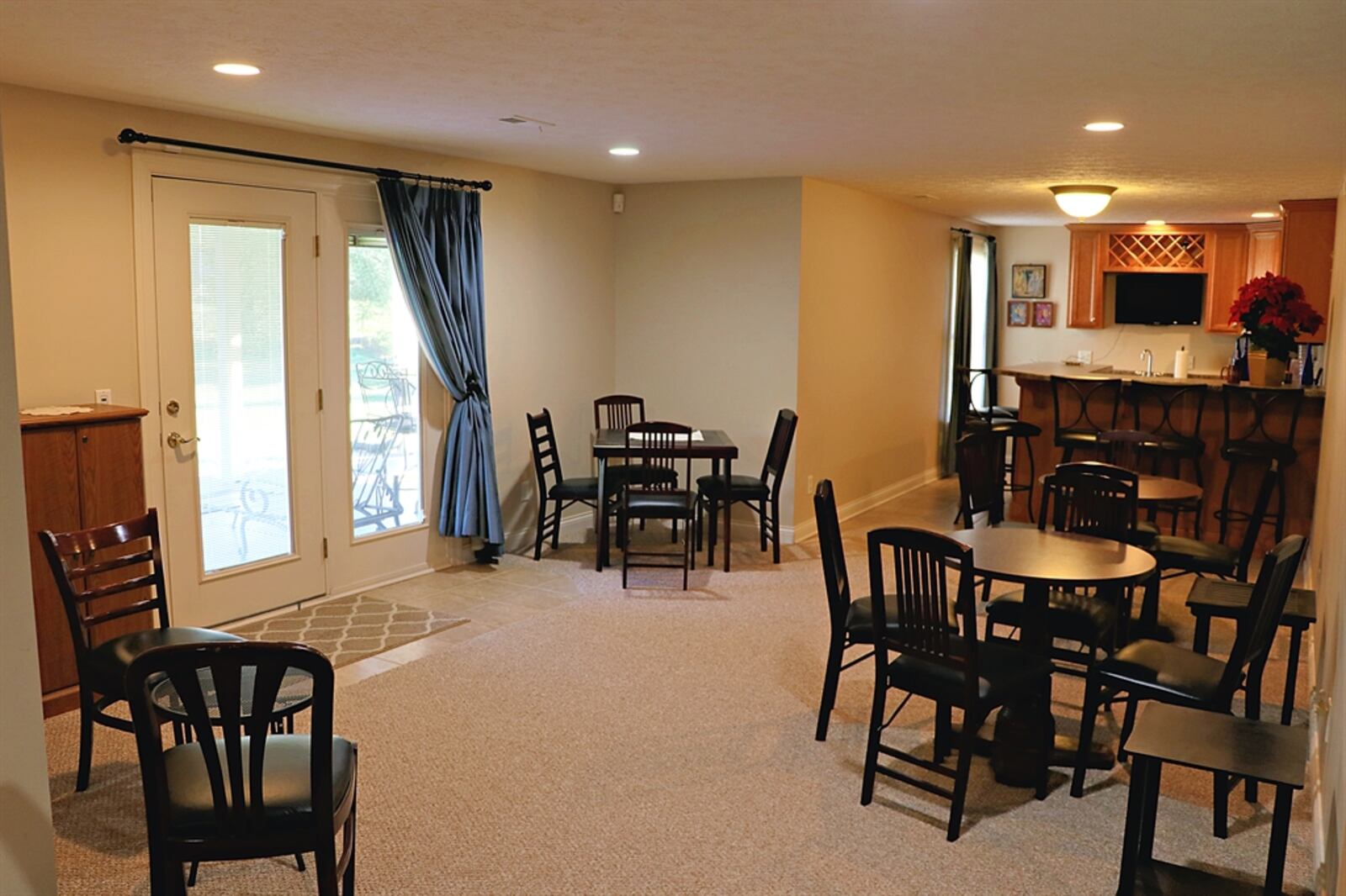 The lower level features a large recreation room with a kitchenette bar area.