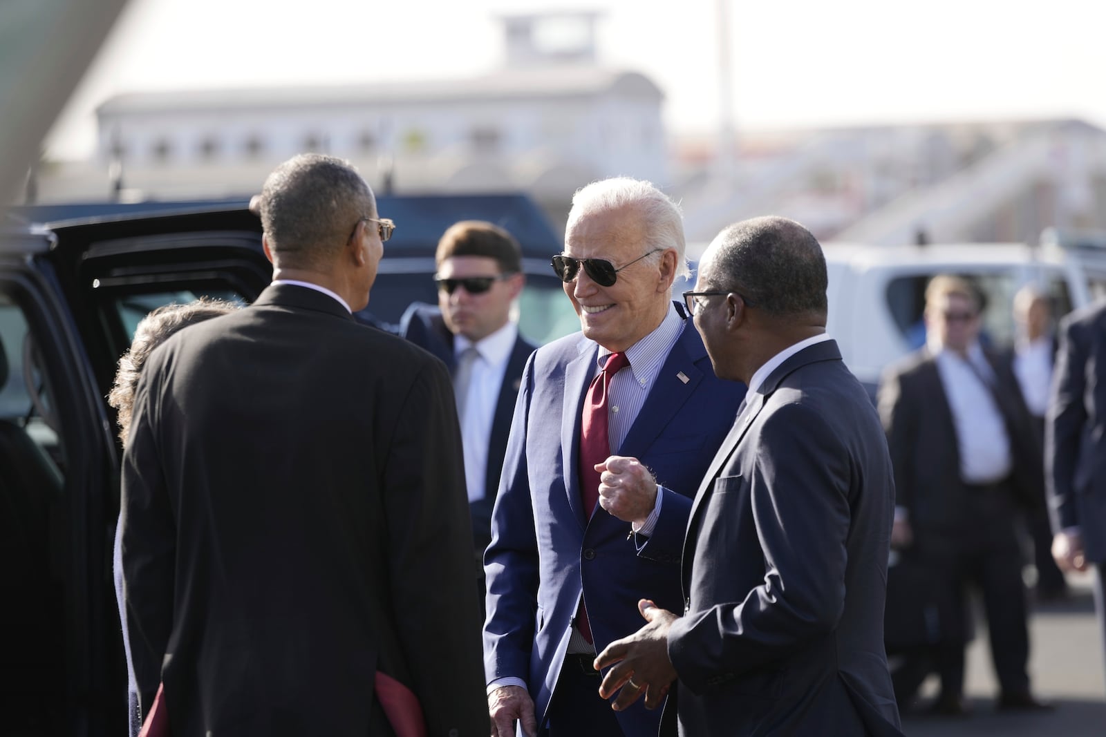 President Joe Biden speaks with Cape Verde's Prime Minister Ulisses Correia e Silva, right, and Jose Luis Livramento, Cabo Verde Ambassador to the U.S at Amilcar Cabral international airport on Sal island, Cape Verde Monday, Dec. 2, 2024, en route to Angola as he makes his long-promised visit to Africa. (AP Photo/Ben Curtis)