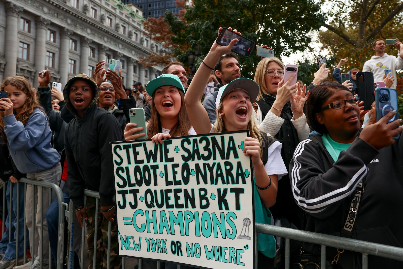 New York Liberty fans react while watching players parade down the Canyon of Heroes on Broadway celebrating the team's WNBA basketball championship, Thursday, Oct. 24, 2024, in New York. (AP Photo/Yuki Iwamura)