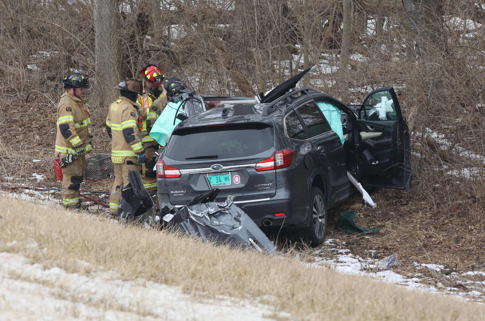 Harmony Twp. fire crews examine the wreckage after an SUV slammed into the back of a broken down flatbed semi trailer Thursday morning, Feb. 10, 2022, on Interstate 70 West in Harmony Twp., killing its driver. BILL LACKEY/STAFF