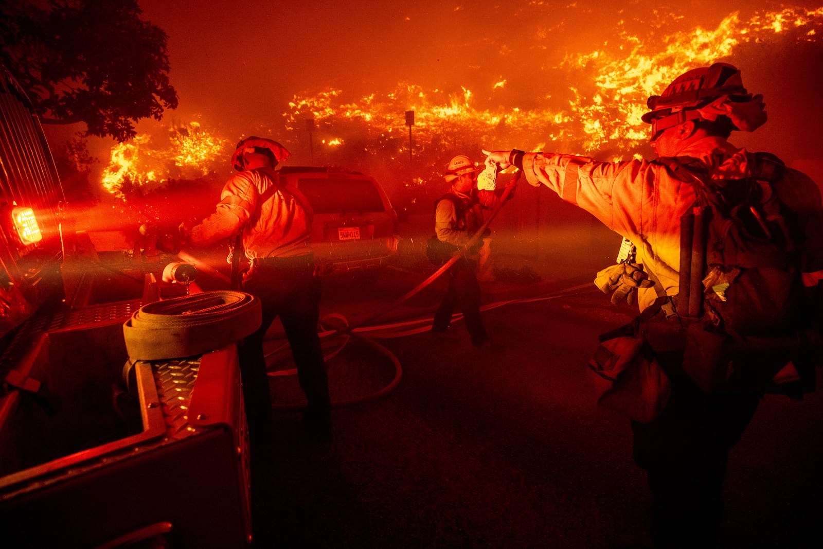 Firefighters battle the Franklin Fire in Malibu, Calif., on Tuesday, Dec. 10, 2024. (AP Photo/Ethan Swope)