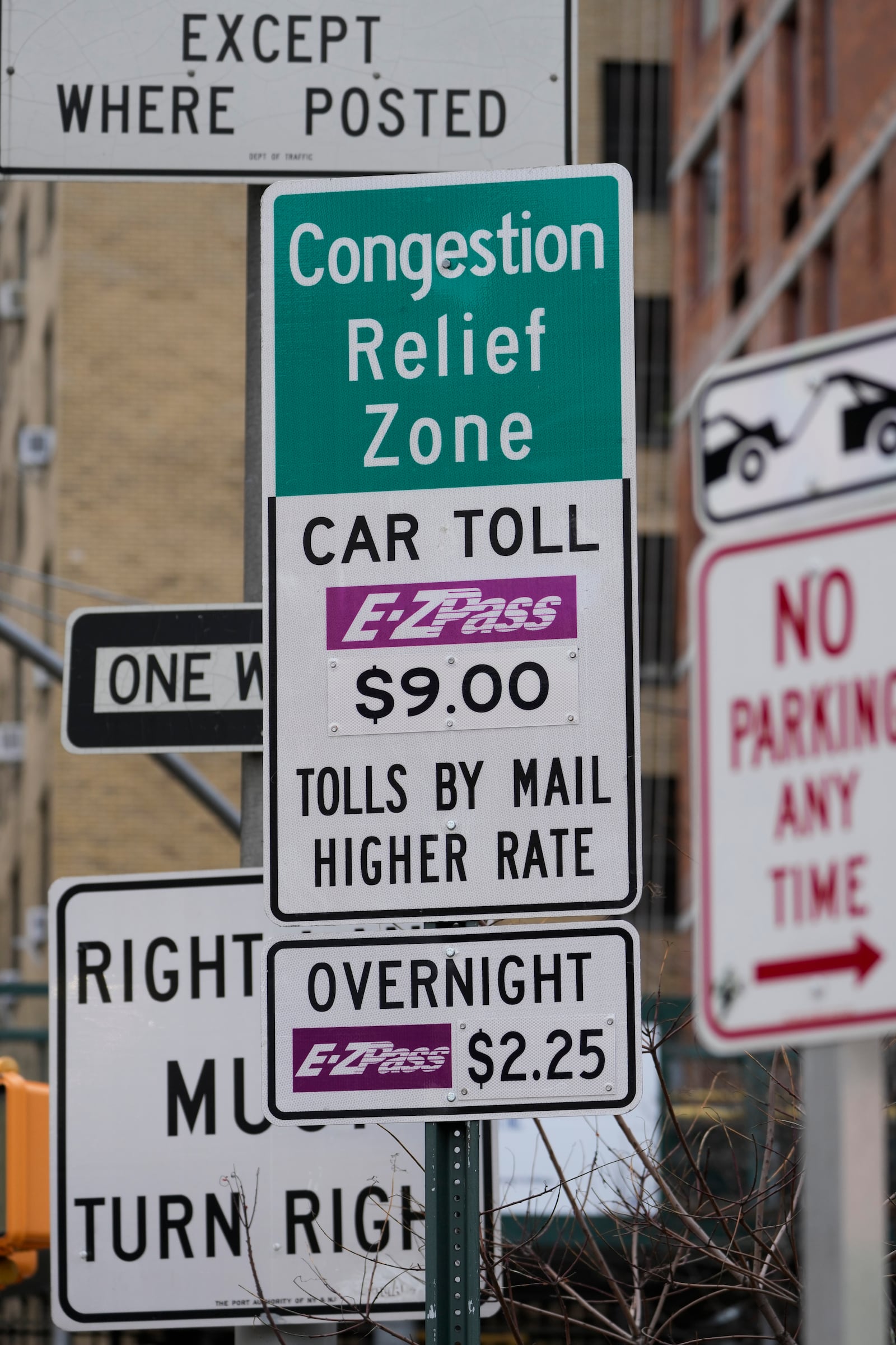 Signs, including some advising drivers of congestion pricing tolls, are displayed near the exit of the Lincoln Tunnel in New York, Wednesday, Feb. 19, 2025. (AP Photo/Seth Wenig)