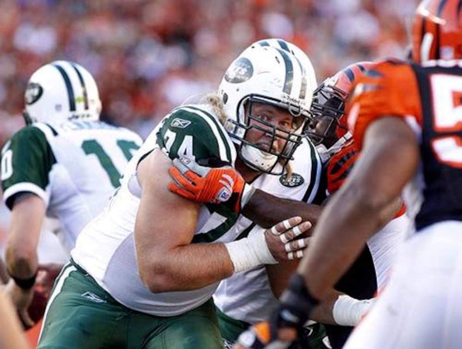 Nick Mangold, the starting center on the Jets offensive line, blocks for the Jets. Mangold graduated from Alter High School and played for Ohio State.