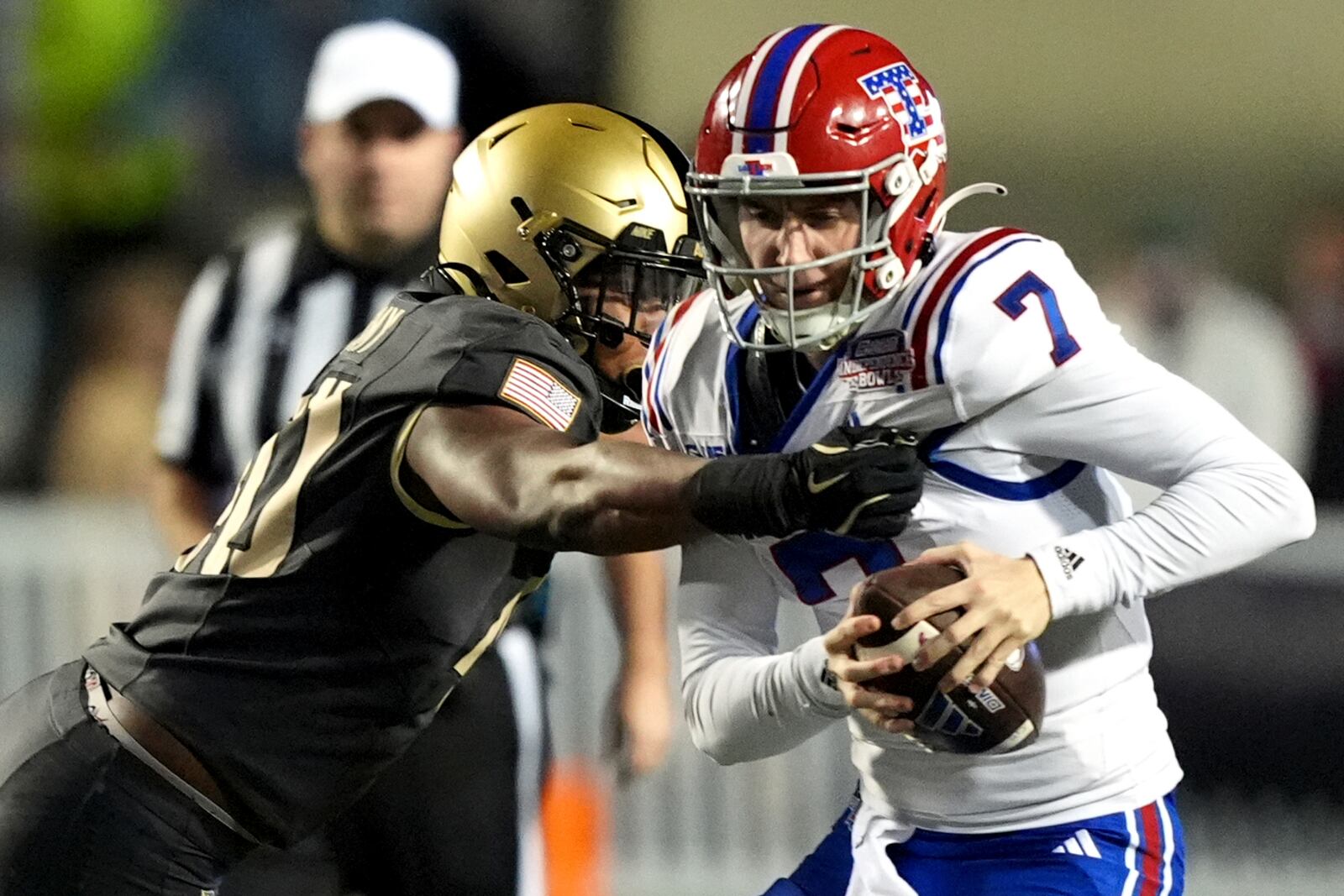 Army linebacker Eric Ford, left, rushes Louisiana Tech quarterback Evan Bullock (7) who was attempting to throw a pass during the first half of the Independence Bowl NCAA college football game, Saturday, Dec. 28, 2024, in Shreveport, La. (AP Photo/Rogelio V. Solis)