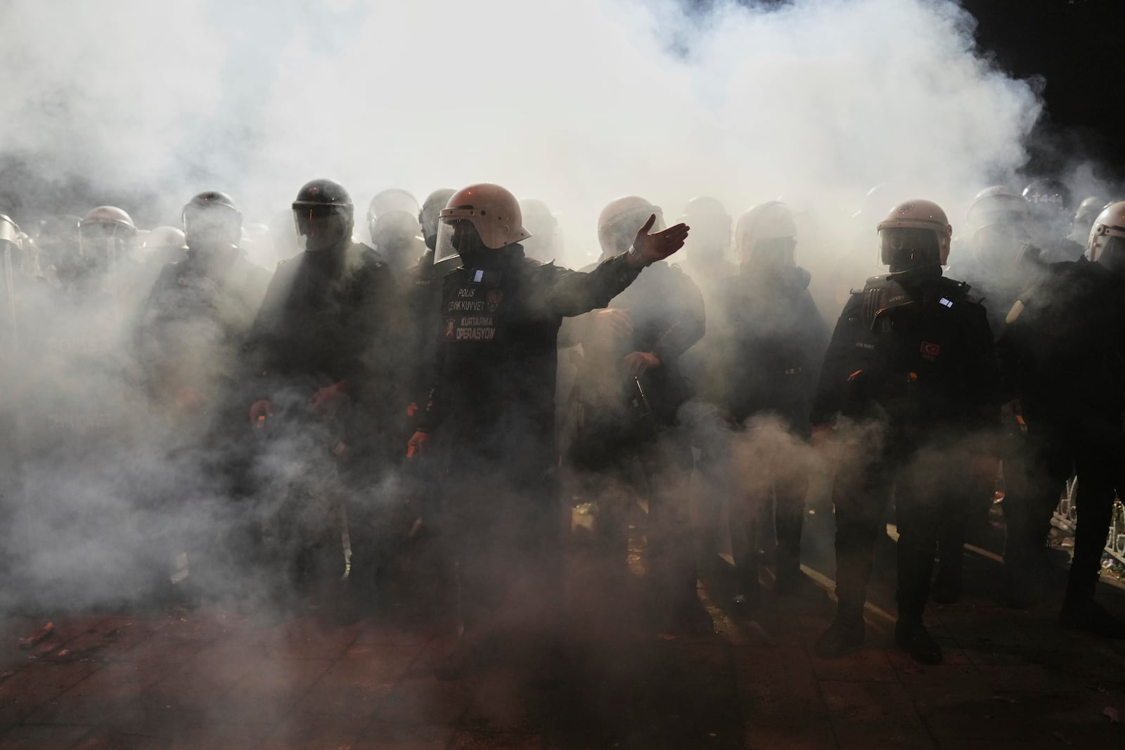 Riot police clash with protesters during a protest against the arrest of Istanbul's Mayor Ekrem Imamoglu, in Istanbul, Turkey, Saturday, March 22, 2025. (AP Photo/Francisco Seco)