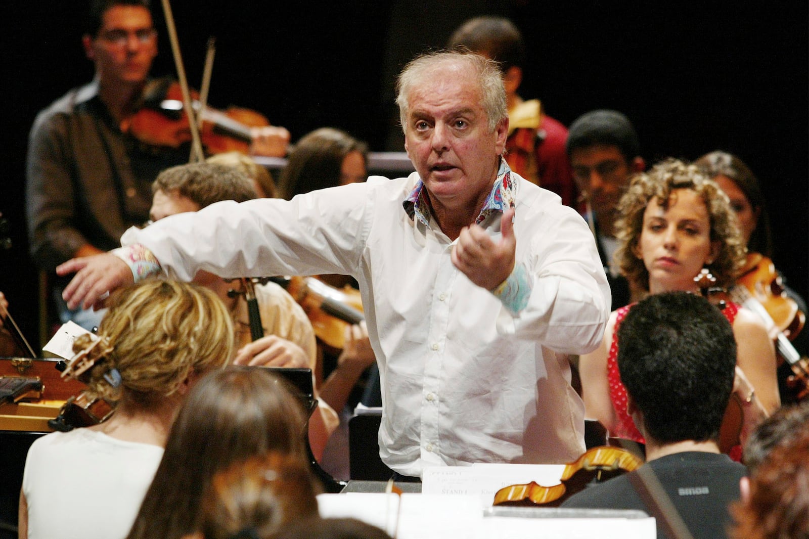 FILE - Daniel Barenboim conducts the West-Eastern Divan Orchestra, which is composed of Israeli and Arab musicians, during a rehearsal at the Royal Albert Hall in London on Aug. 22, 2003. (AP Photo/Alastair Grant, File)