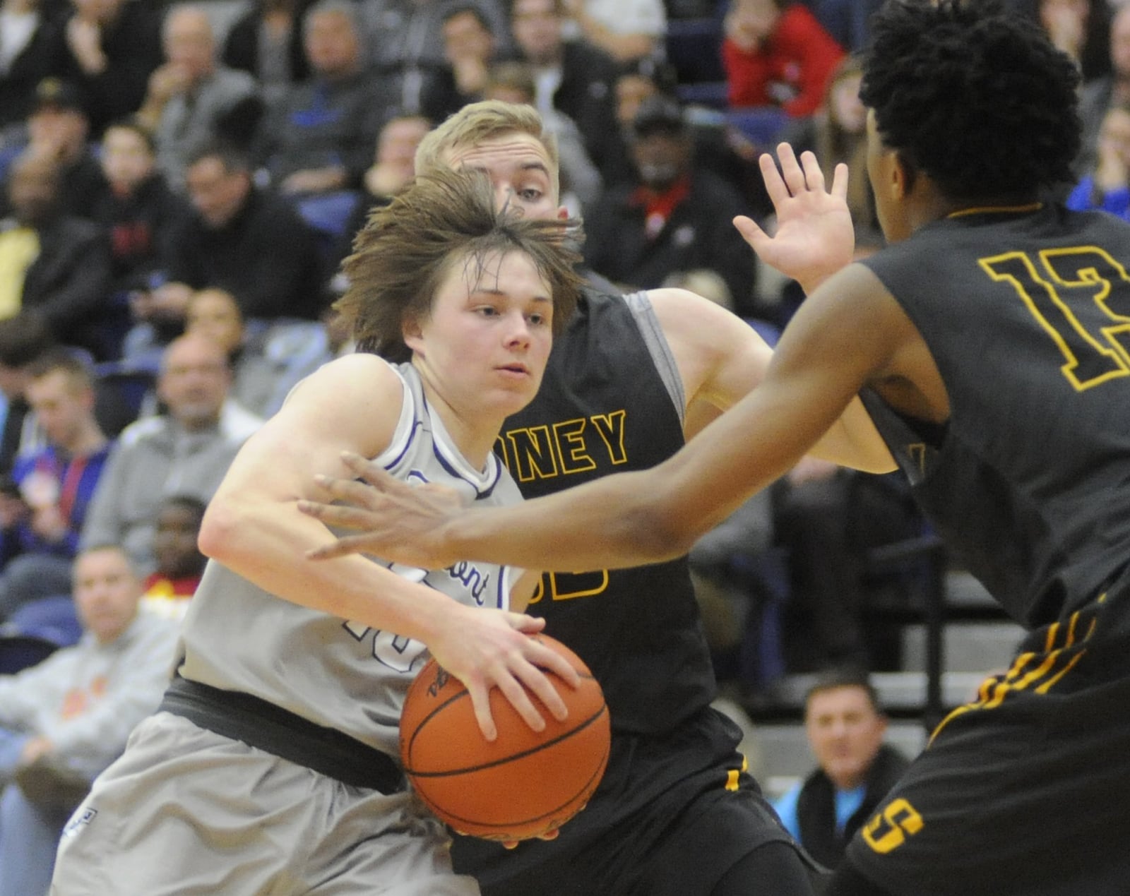 Fairmont’s Jack Hendricks (with ball) is met by Sidney defenders Chris Lee (middle) and Ratez Roberts. Fairmont defeated Sidney 60-51 in the 15th annual Premier Health Flyin’ to the Hoop opener at Kettering’s Trent Arena on Friday, Jan. 13, 2017. MARC PENDLETON / STAFF