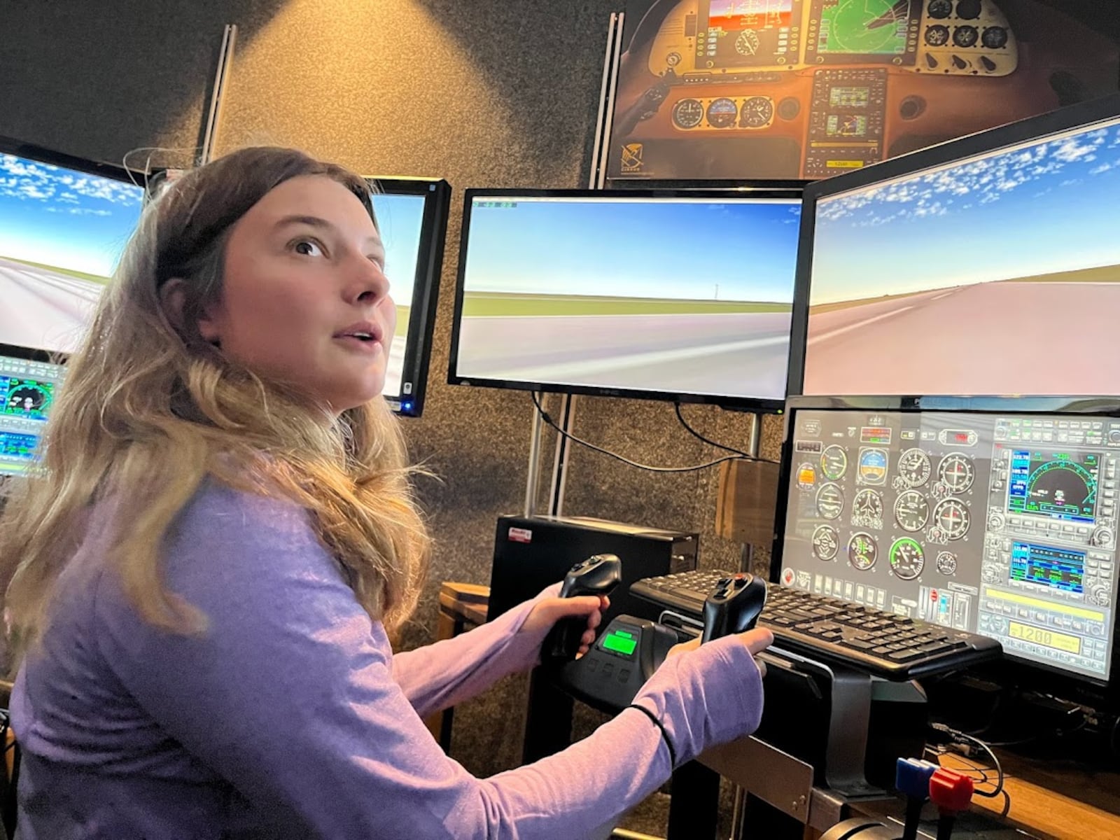 Oakwood High School student Lily Epley, 17, takes her turn on a flight simulator at the Lewis Jackson Airport in Greene County on Nov. 5. THOMAS GNAU/STAFF