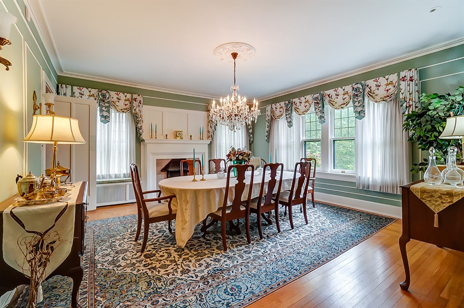 The dining room walls have picture-frame wainscoting and crown molding. A fireplace has a bold mantel and marble surround. A swinging door opens into a butler’s pantry, which has been updated to include bottle and glass racks, cabinetry, granite countertops for a coffee station and a mini-refrigerator. CONTRIBUTED PHOTO