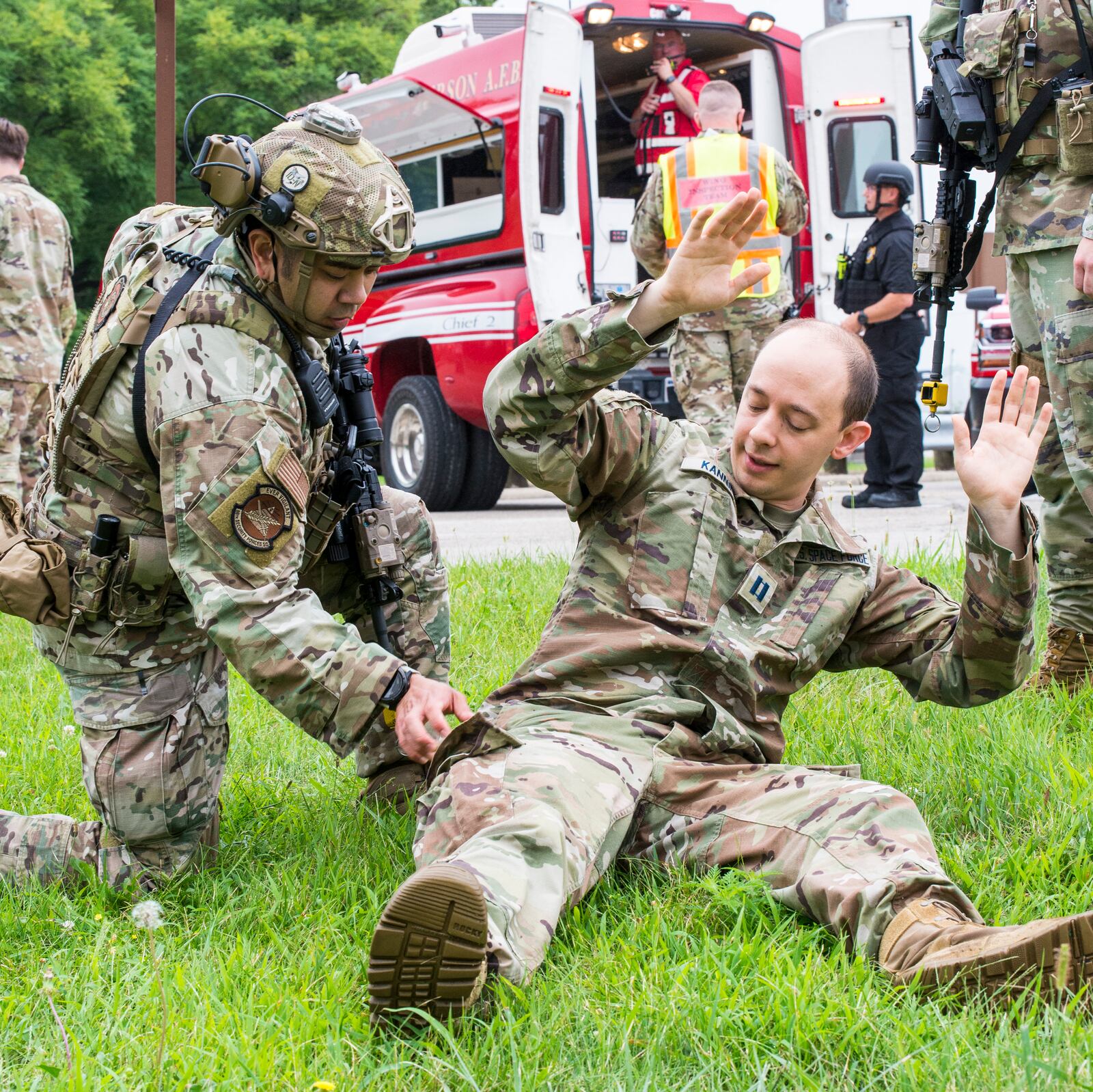 Master Sgt. Joseph McDowell (left), 88th Security Forces Squadron, reaches into the pocket of Capt. Matthew Canning, 88th Communications Squadron director of operations, to retrieve identification during an active-shooter exercise Aug. 10 at Wright-Patterson Air Force Base. The exercise was conducted to test the skills of first responders in a potential real-world scenario. U.S. AIR FORCE PHOTO/JAIMA FOGG