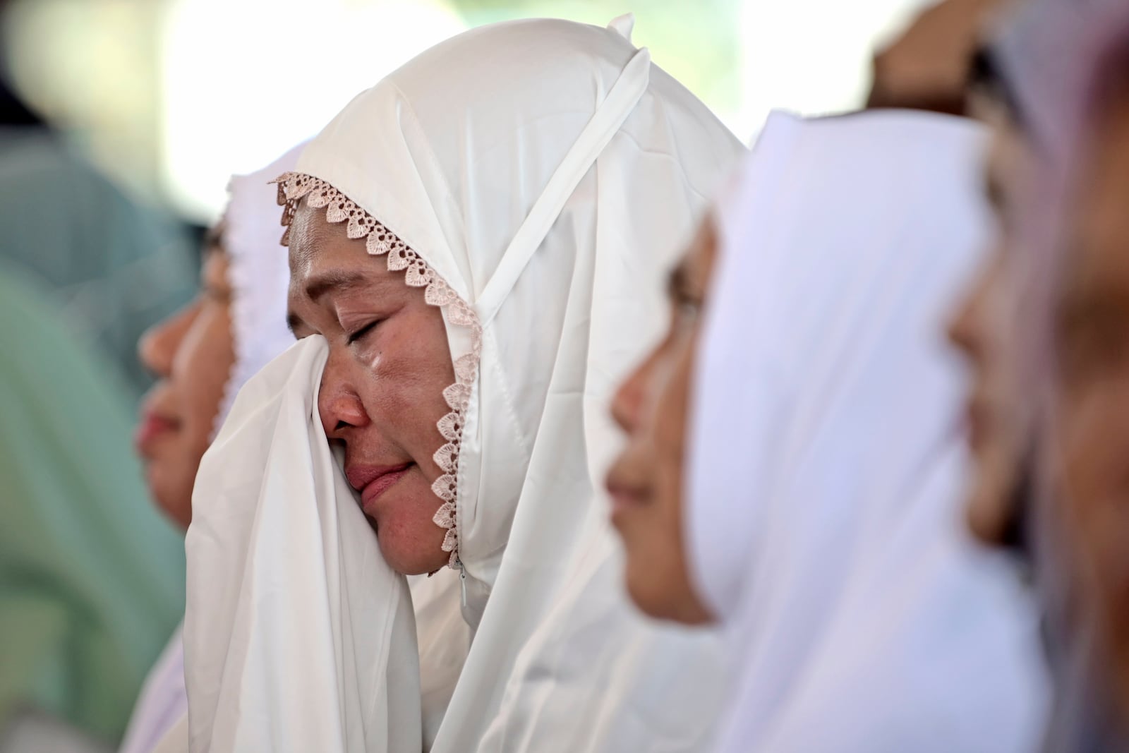 A woman weeps during a prayer marking 20 years of the massive Indian Ocean tsunami, in Banda Aceh, Indonesia, Thursday, Dec. 26, 2024. (AP Photo/Reza Saifullah)