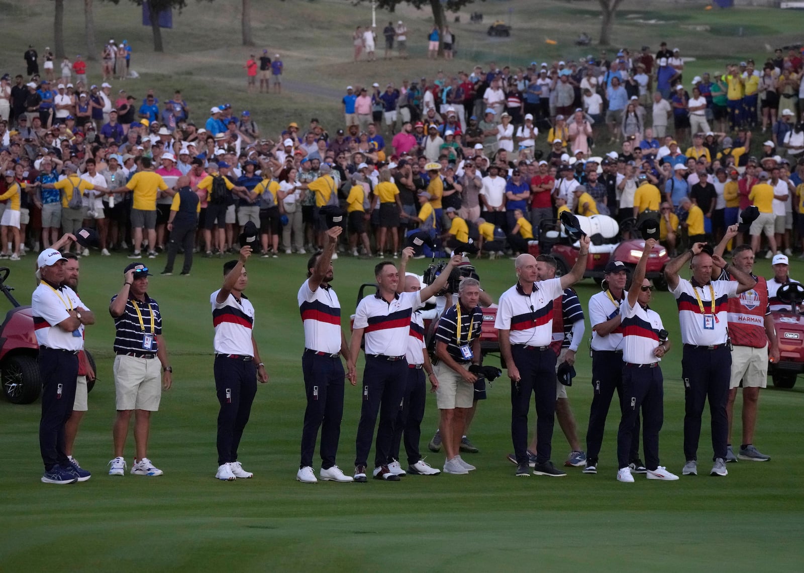 FILE - Members off the United States Ryder Cup team cheer United States' Patrick Cantlay after he won his afternoon Fourballs match on the 18th green at the Ryder Cup golf tournament at the Marco Simone Golf Club in Guidonia Montecelio, Italy, Sept. 30, 2023. (AP Photo/Alessandra Tarantino, file)