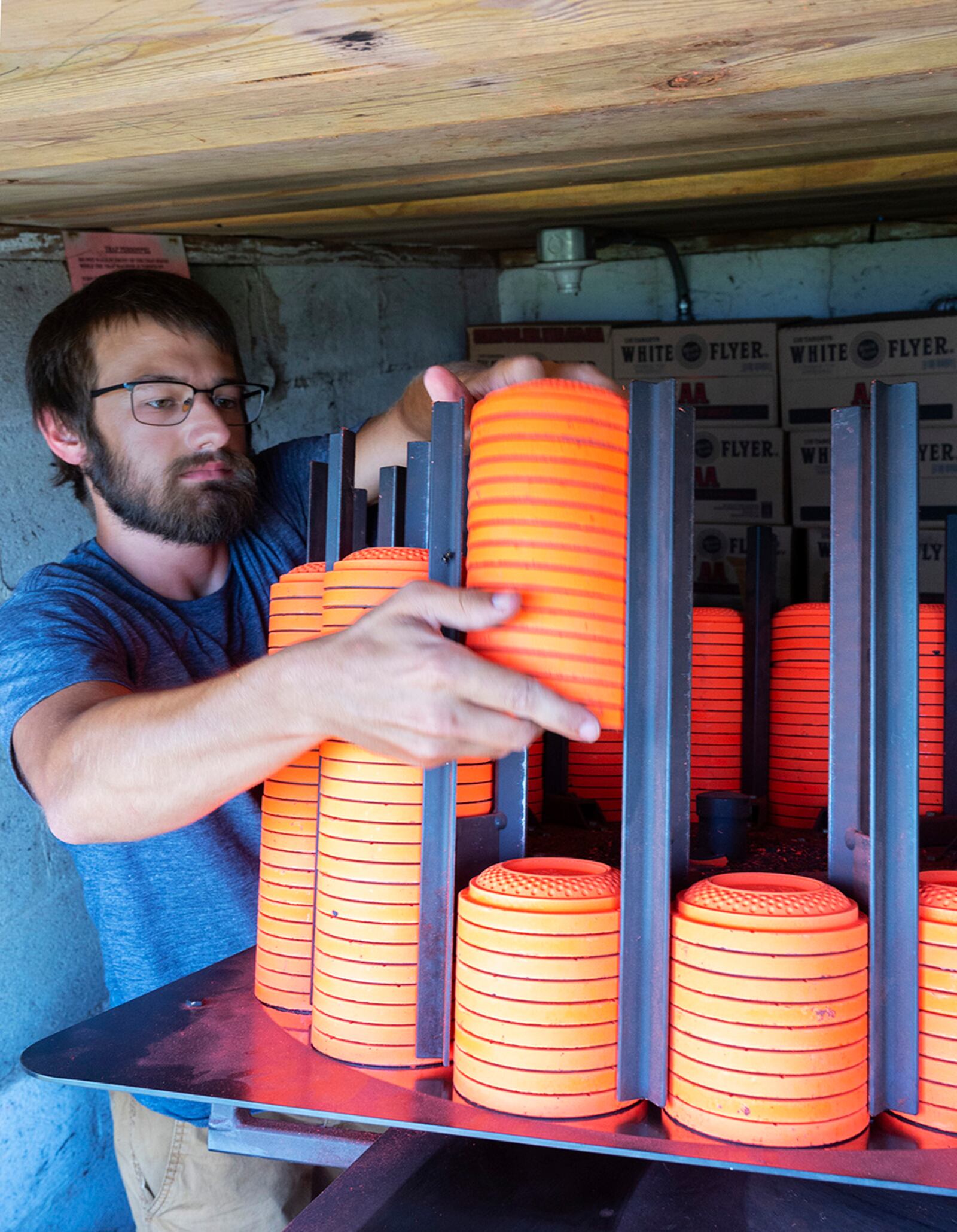 David Miotke, who works at the 88th Force Support Squadron’s Rod and Gun Club, loads clay pigeons into the machine that will fling them downrange from a trap house Aug. 24 at Wright-Patterson Air Force Base. A round of skeet or trap shooting includes 25 attempts at the flying disks. U.S. AIR FORCE PHOTO/R.J. ORIEZ