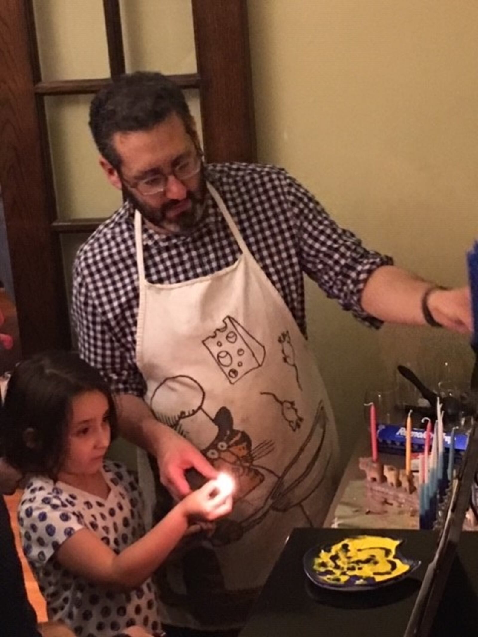 Sam Dorf makes latkes with his daughter, Lana. CONTRIBUTED