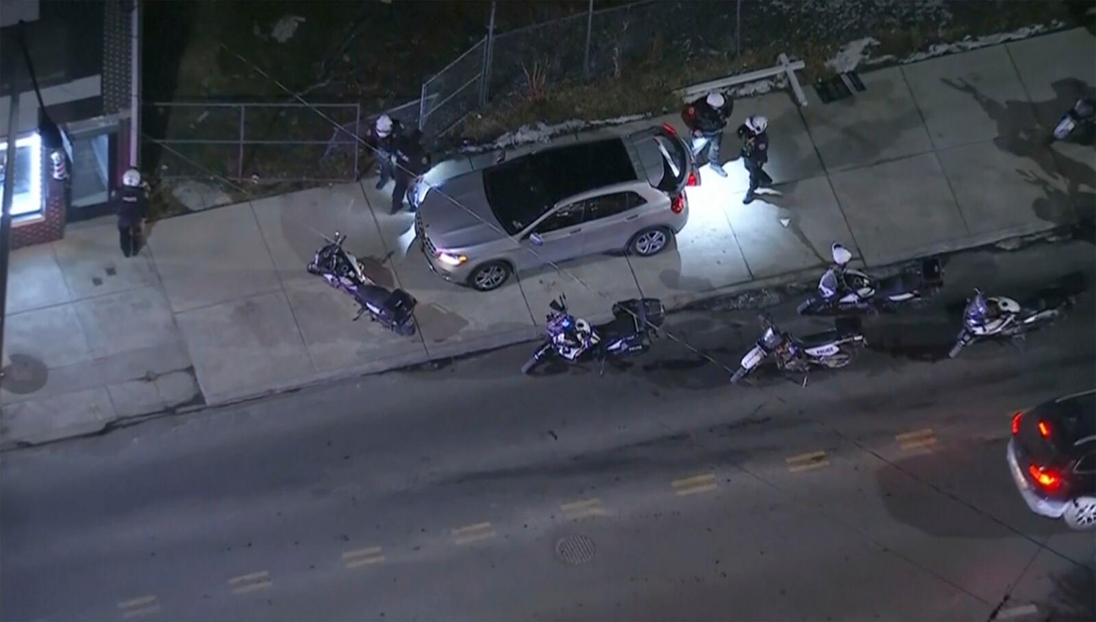 In this image from a video, officers examine a vehicle that police say injured pedestrians in a crowd of people that was leaving the Philadelphia Eagles playoff game, in Philadelphia, Sunday, Jan. 26, 2025. (WPVI-TV/6ABC via AP)