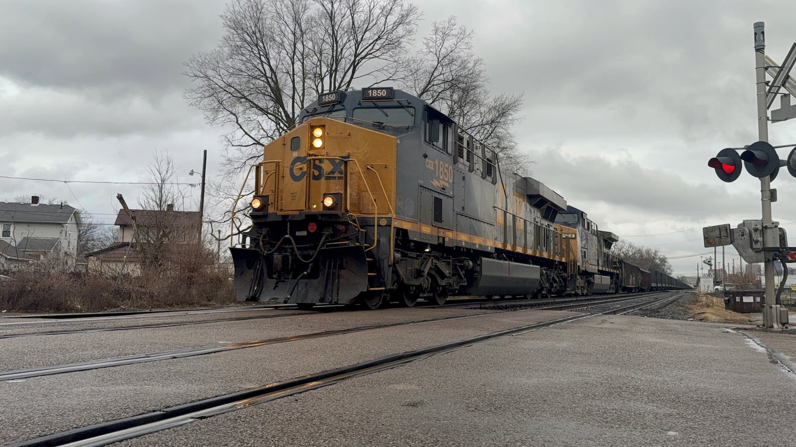 A CSX freight train approaches an at-grade rail crossing on Weaver Street in Dayton's Edgemont neighborhood in late December 2024. CORNELIUS FROLIK / STAFF