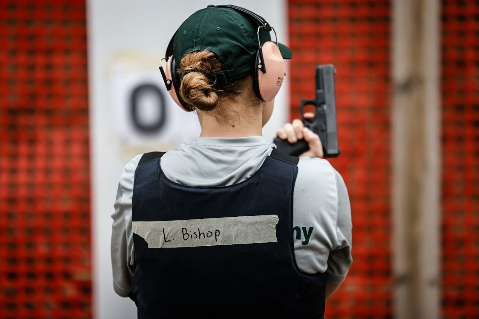 Dayton Daily News reporter London Bishop gets ready to shoot during training at the gun range. JIM NOELKER/STAFF