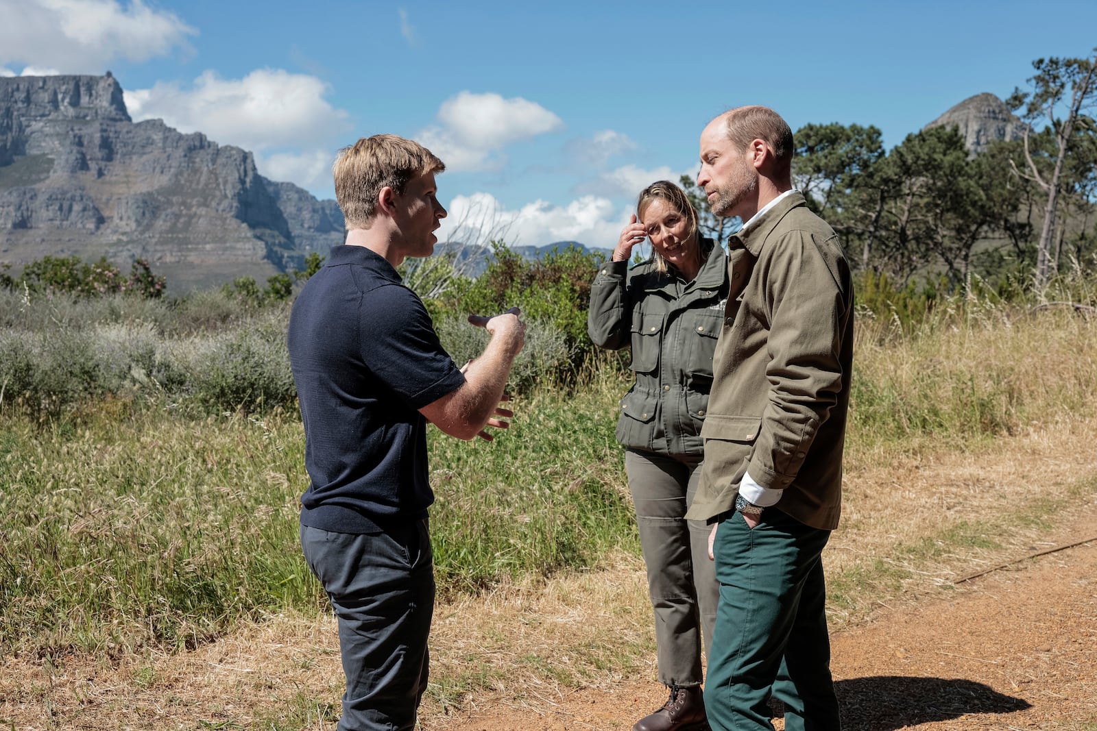 Britain's Prince William talks with Park Manager for Table Mountain National Park Megan Taplin, center, and Australian conservationist and Earthshot Prize Global Ambassador Robert Irwin while visiting Signal Hill in Cape Town, South Africa, Tuesday, Nov. 5, 2024. (Gianluigi Guercia/Pool via AP)