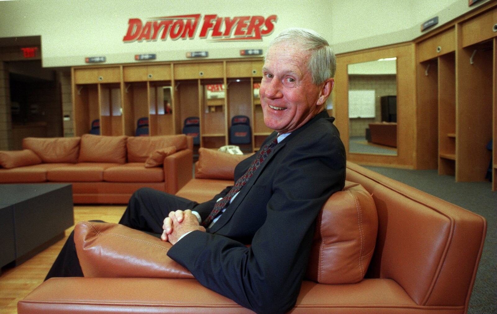 Former Dayton basketball coach Don Donoher relaxes on a leather couch in the new men’s basketball locker room at the Donoher Basketball Center in 1998. Donoher coached the 1966-67 Flyers to a runner-up finish in the NCAA Tournament. FILE PHOTO