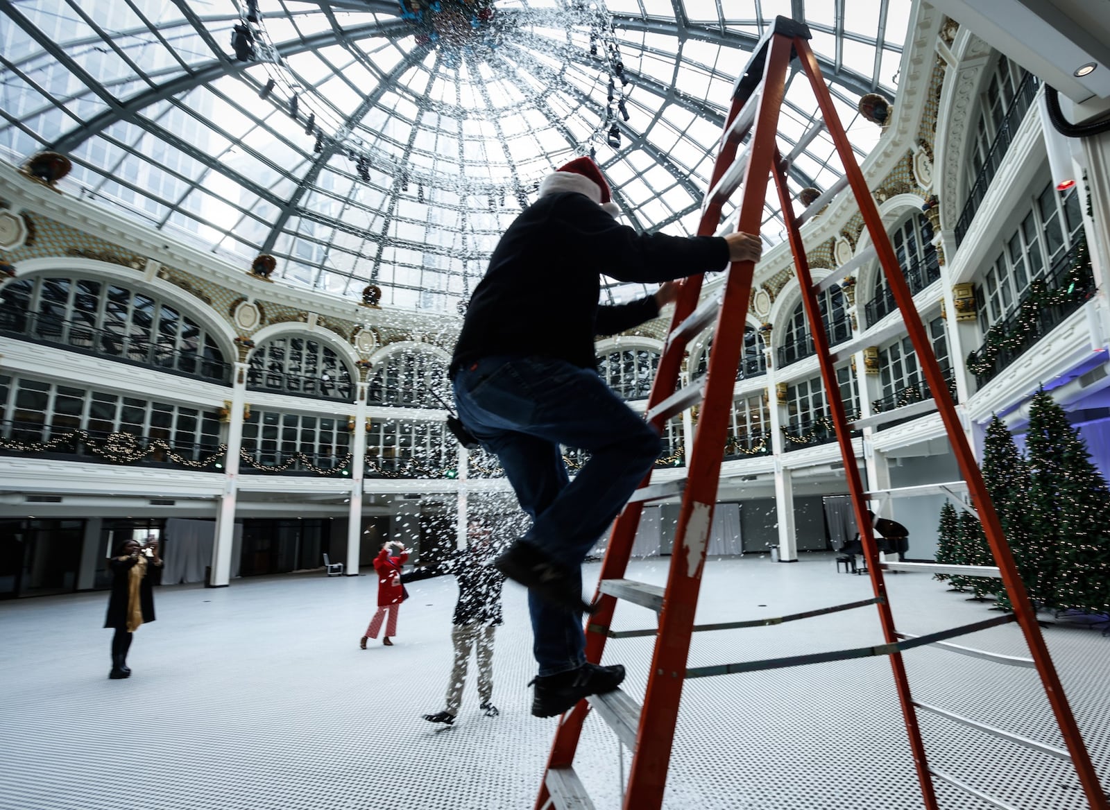 Brian Cox, operations for the Dayton Arcade events, adjust the snow machine for the Holly Days event coming this week at the Dayton Arcade. JIM NOELKER/STAFF