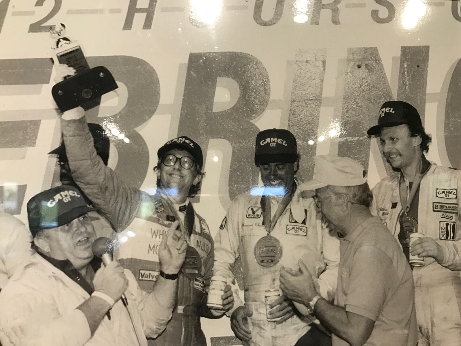 John Higgins (left) celebrates in Victory Lane with his co-drivers, Howard Cherry, and Dr. Charles Monk after winning the Lights division of the 12 hours of Sebring in 1987. CONTRIBUTED