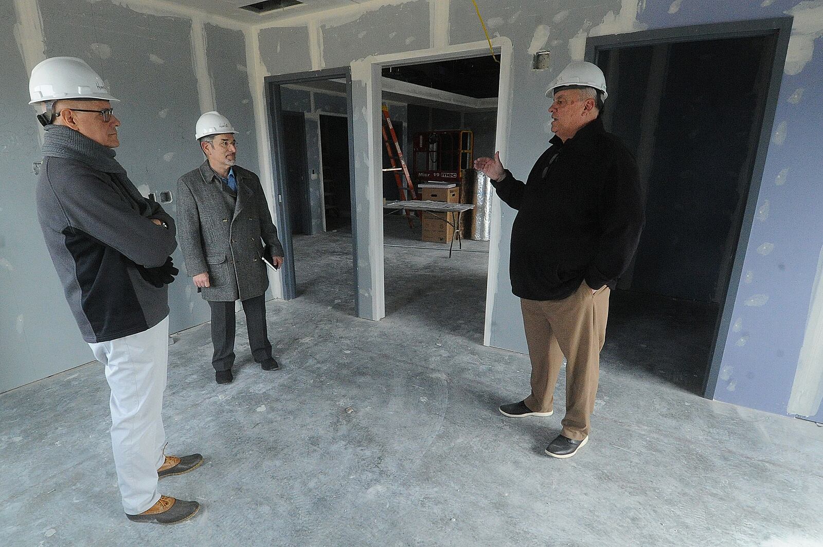 From left, Bear Monita, partner LWC Inc., John Fabelo, LWC, Director of Design, and John Patterson, Chief Business Developmont Officer, talk about the progress on Homefull’s new West Dayton grocery store on South Gettysburg Ave. Friday, Feb. 16, 2024.  Homefull hopes to redevelop the entire 16-acre site, starting with this project which will include a grocery store, food hub, pharmacy and medical services and community spaces. MARSHALL GORBY\STAFF