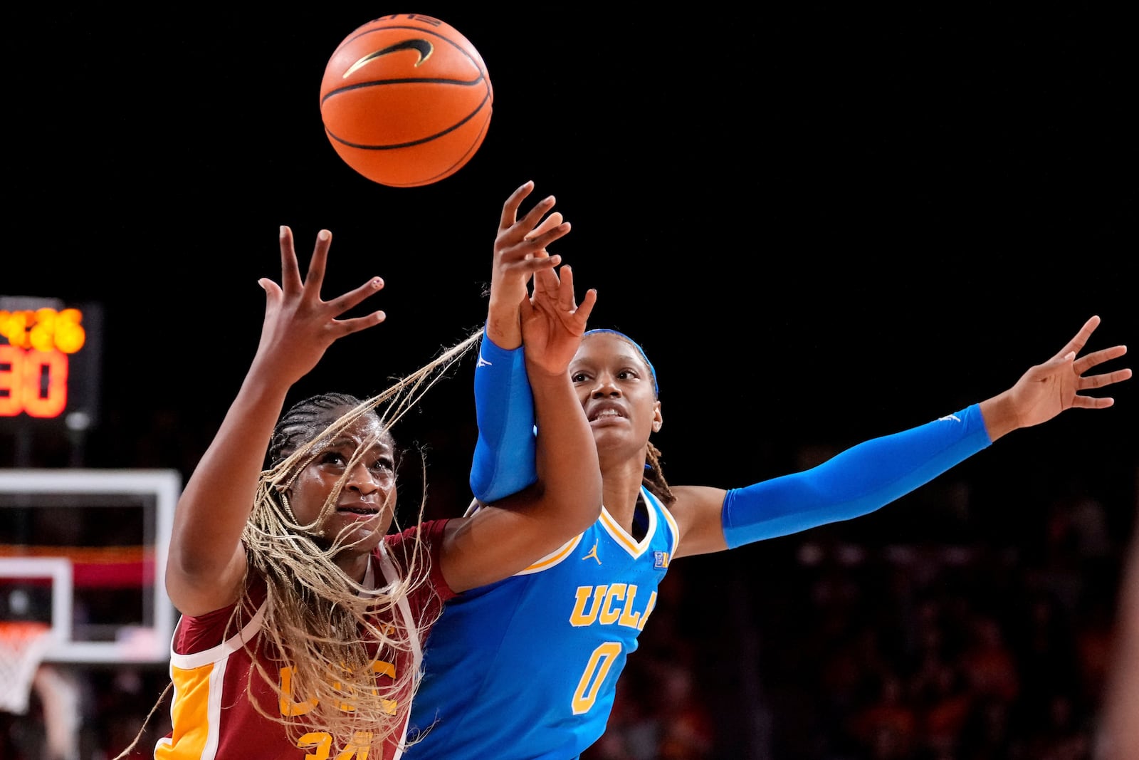 Southern California center Clarice Akunwafo, left, and UCLA forward Janiah Barker reach for the ball during the first half of an NCAA college basketball game, Thursday, Feb. 13, 2025, in Los Angeles. (AP Photo/Mark J. Terrill)