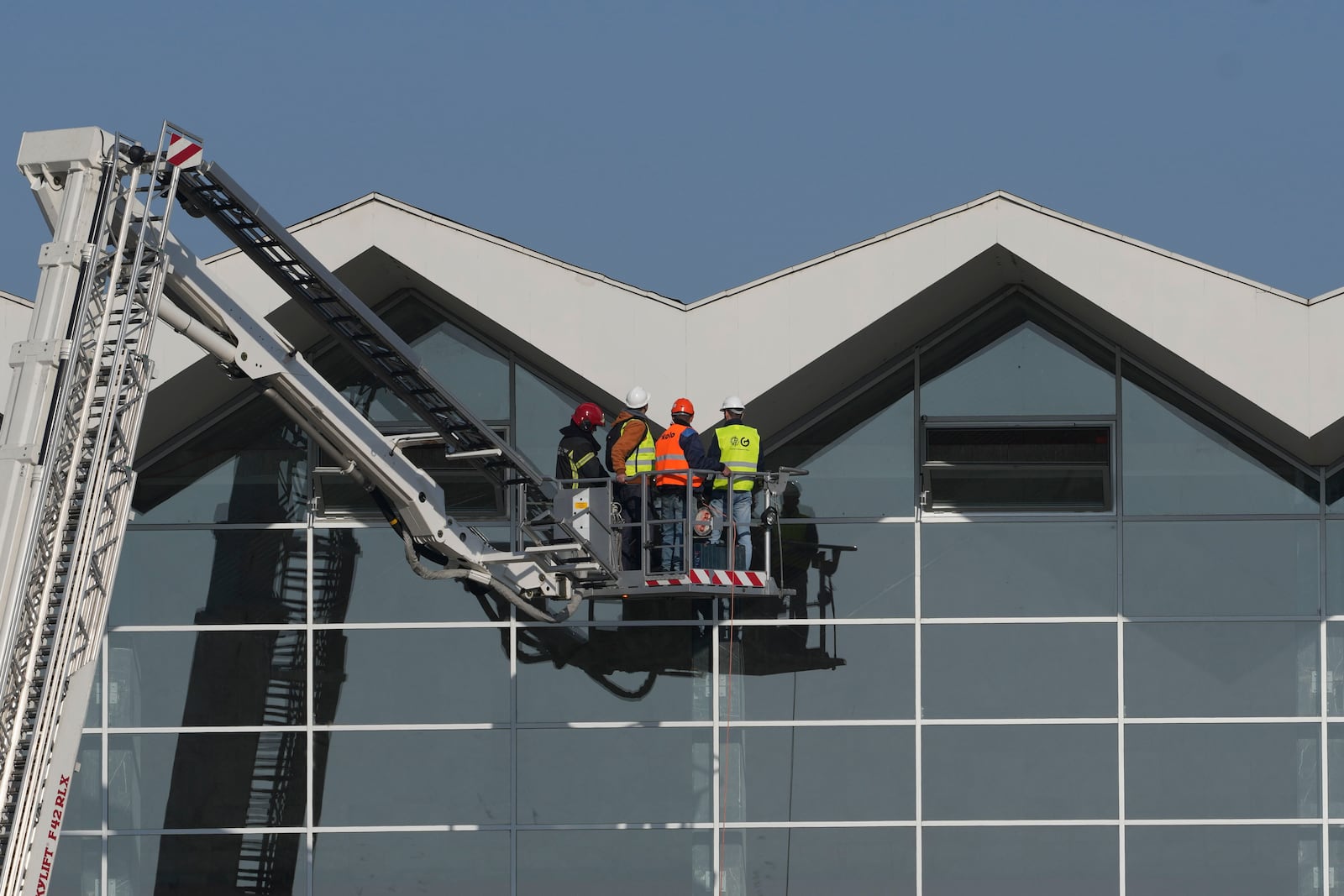 Workers inspect a train station after an outdoor roof collapsed in Novi Sad, Serbia, Saturday, Nov. 2, 2024. (AP Photo/Darko Vojinovic)