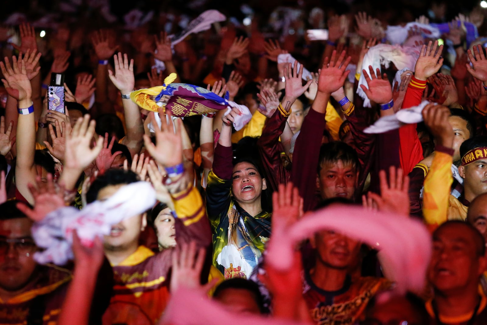 Devotees raise their hands as they join the annual procession of Jesus Nazareno in Manila, Philippines, Thursday. Jan. 9, 2025. (AP Photo/Basilio Sepe)