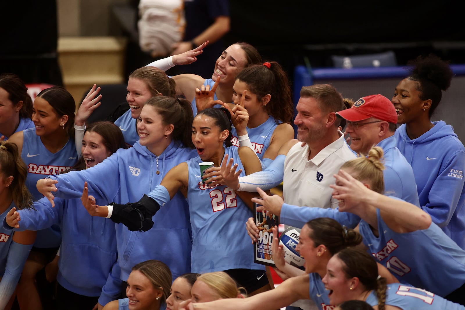 Dayton celebrates coach Tim Horsmon's 400th career victory with the program after a match against Davidson on Friday, Nov. 8, 2024, at the Frericks Center in Dayton. David Jablonski/Staff