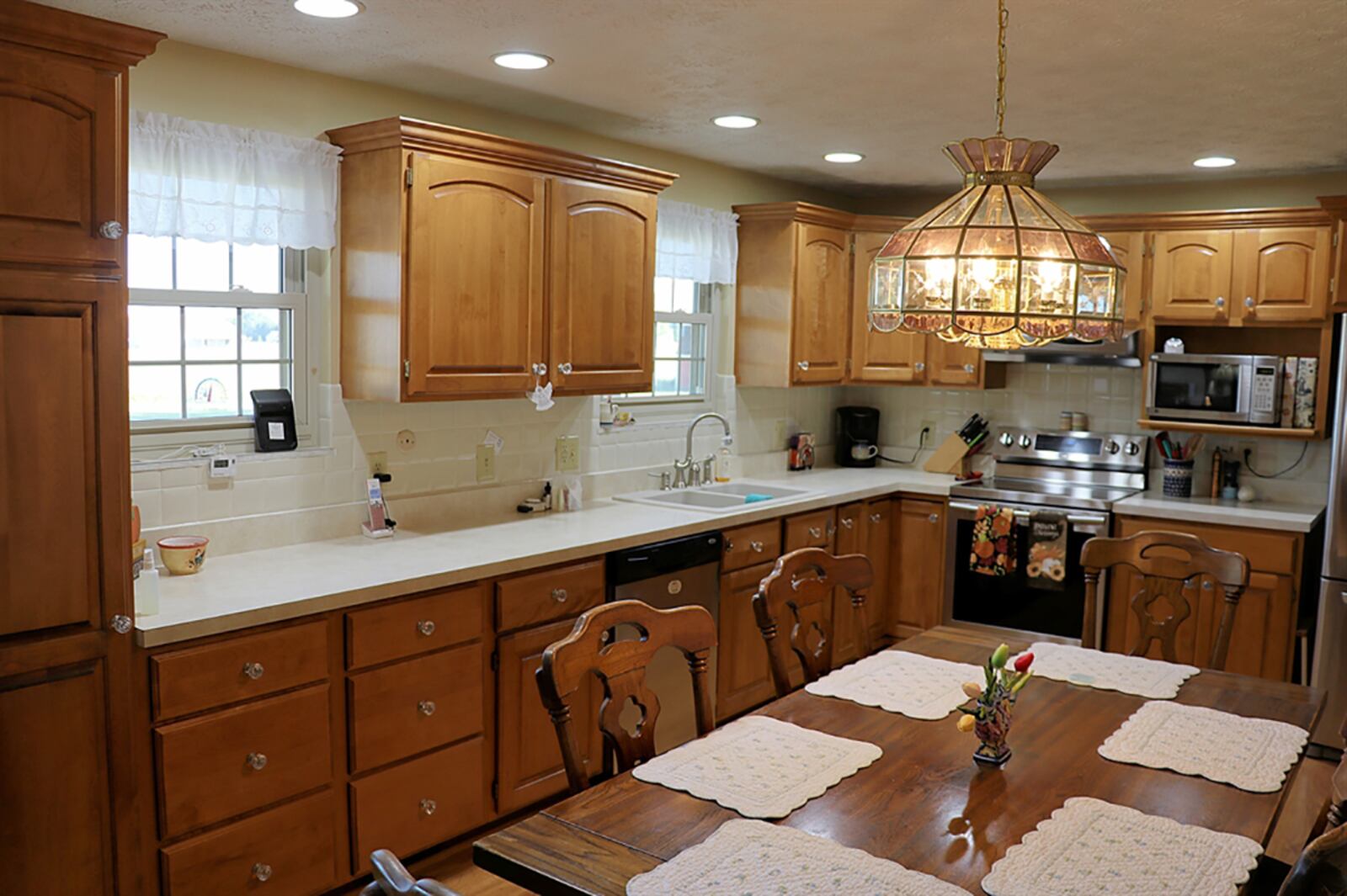 The kitchen has two walls of cabinetry that wrap around stainless-steel appliances, which include a range, dishwasher and refrigerator. There is a pantry cabinet and microwave shelf. Wood-laminate flooring fills the kitchen. CONTRIBUTED PHOTO BY KATHY TYLER