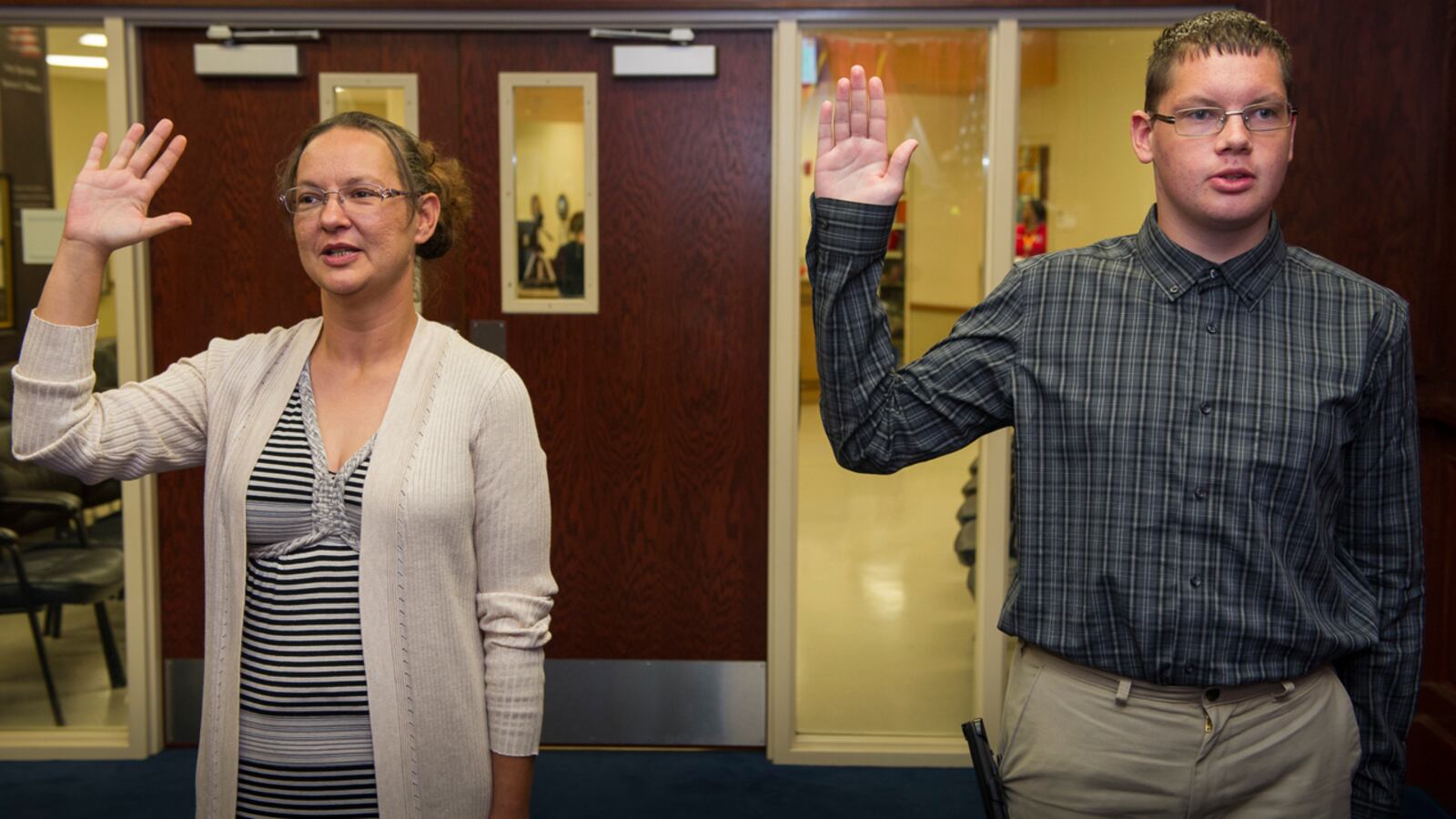 Melissa Ensey and her son, Curtis Abbott, swear into the Navy together at the Kansas City, Mo., Military Entrance Processing Station (MEPS).