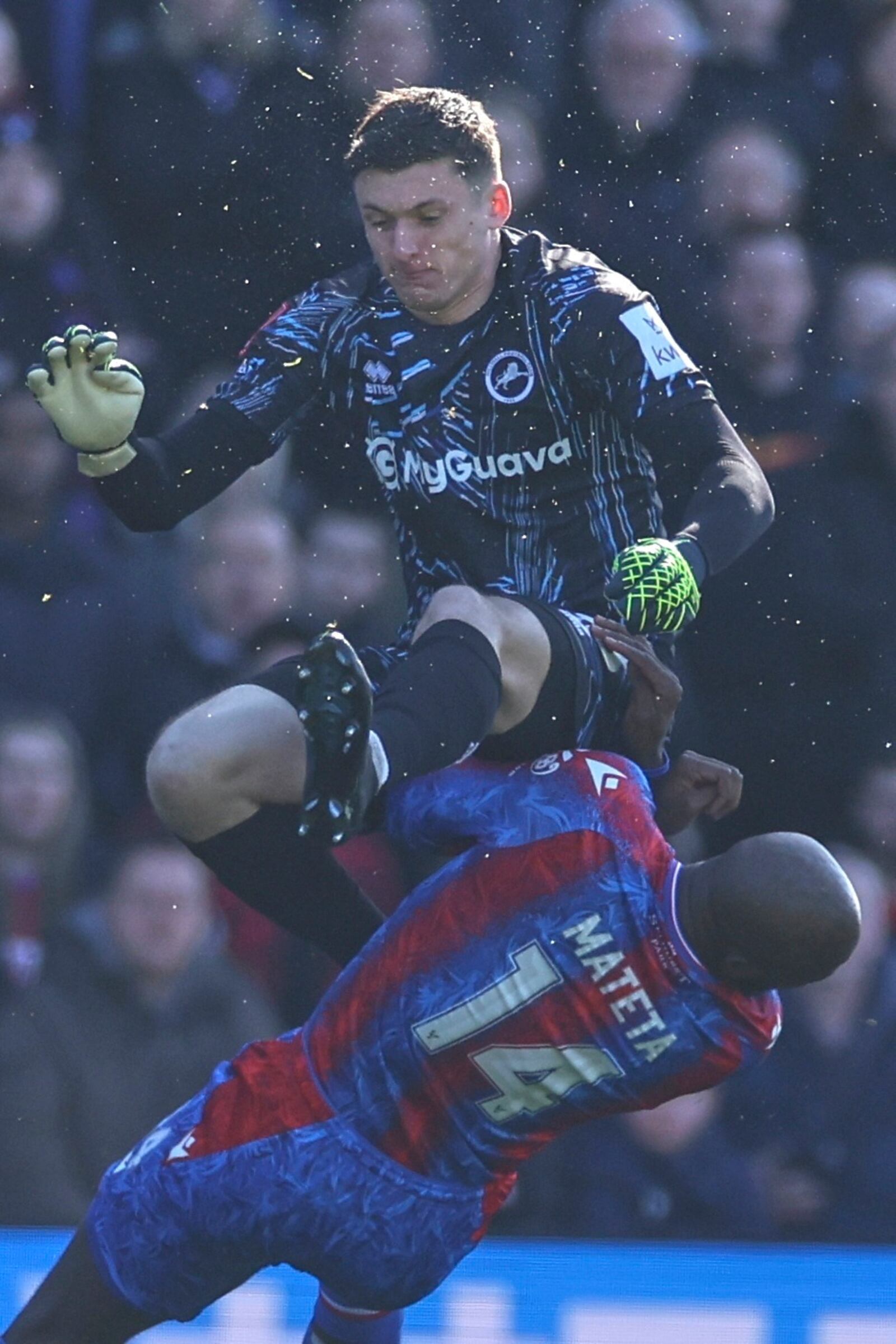 Crystal Palace's Jean-Philippe Mateta is fouled by Millwall goalkeeper Liam Roberts, for which he got a red card, during the English FA Cup soccer match between Crystal Palace and Millwall at Selhurst Park, London, England, Saturday, March 1, 2025. (AP Photo/Ian Walton)