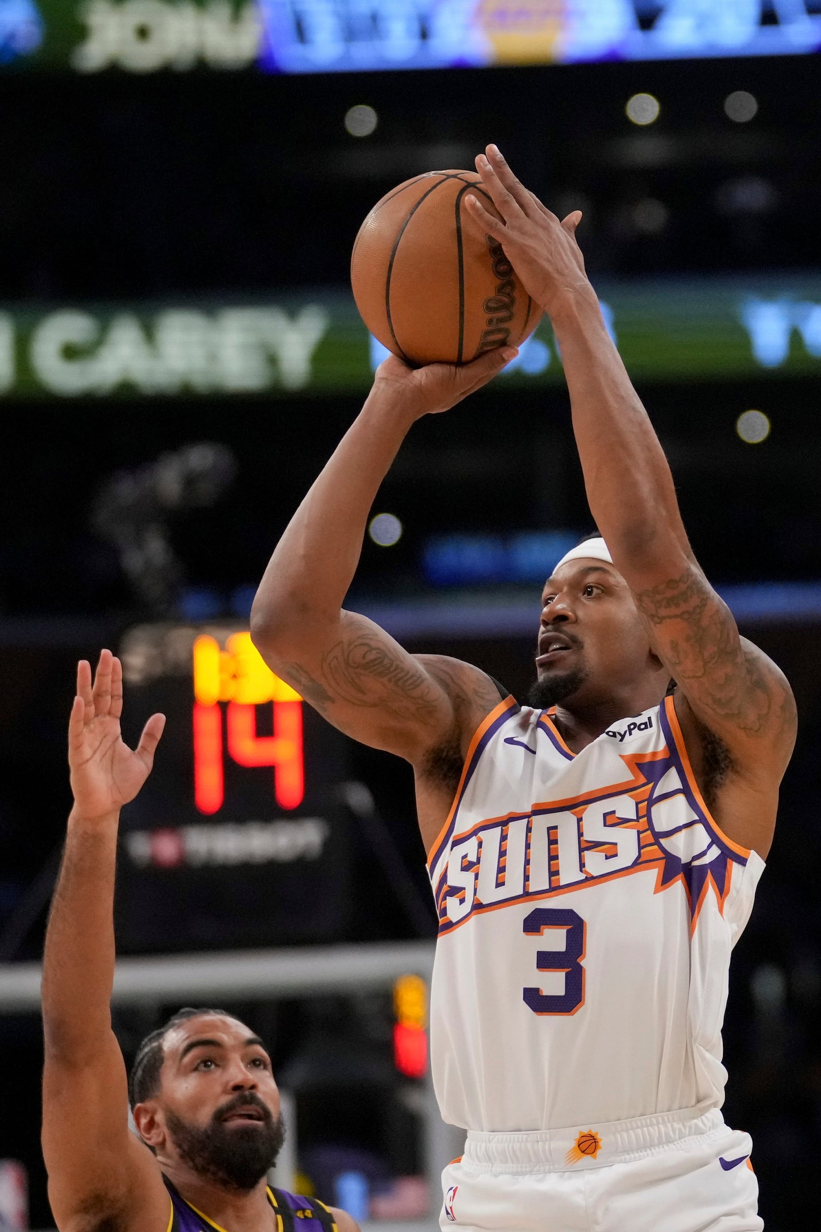 Phoenix Suns guard Bradley Beal (3) shoots over Los Angeles Lakers guard Gabe Vincent during the first half of an NBA basketball game against the in Los Angeles, Friday, Oct. 25, 2024. (AP Photo/Eric Thayer)