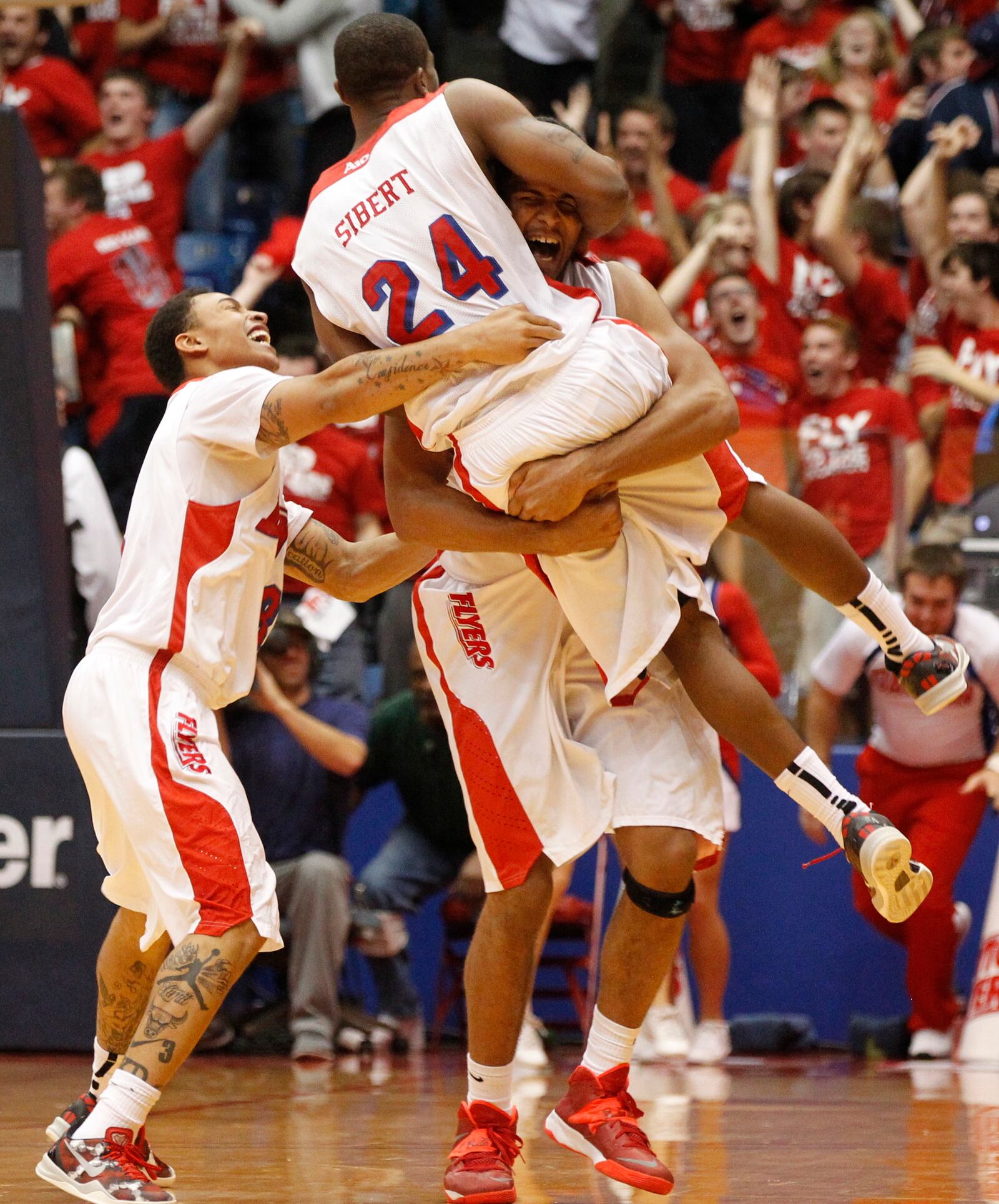 Devin Oliver picks up Jordan Sibert after Sibert's game-winning 3-pointer with 1 second left against IPFW on Saturday, Nov. 9, 2013, at UD Arena. Guard Kyle Davis is at left. David Jablonski/Staff