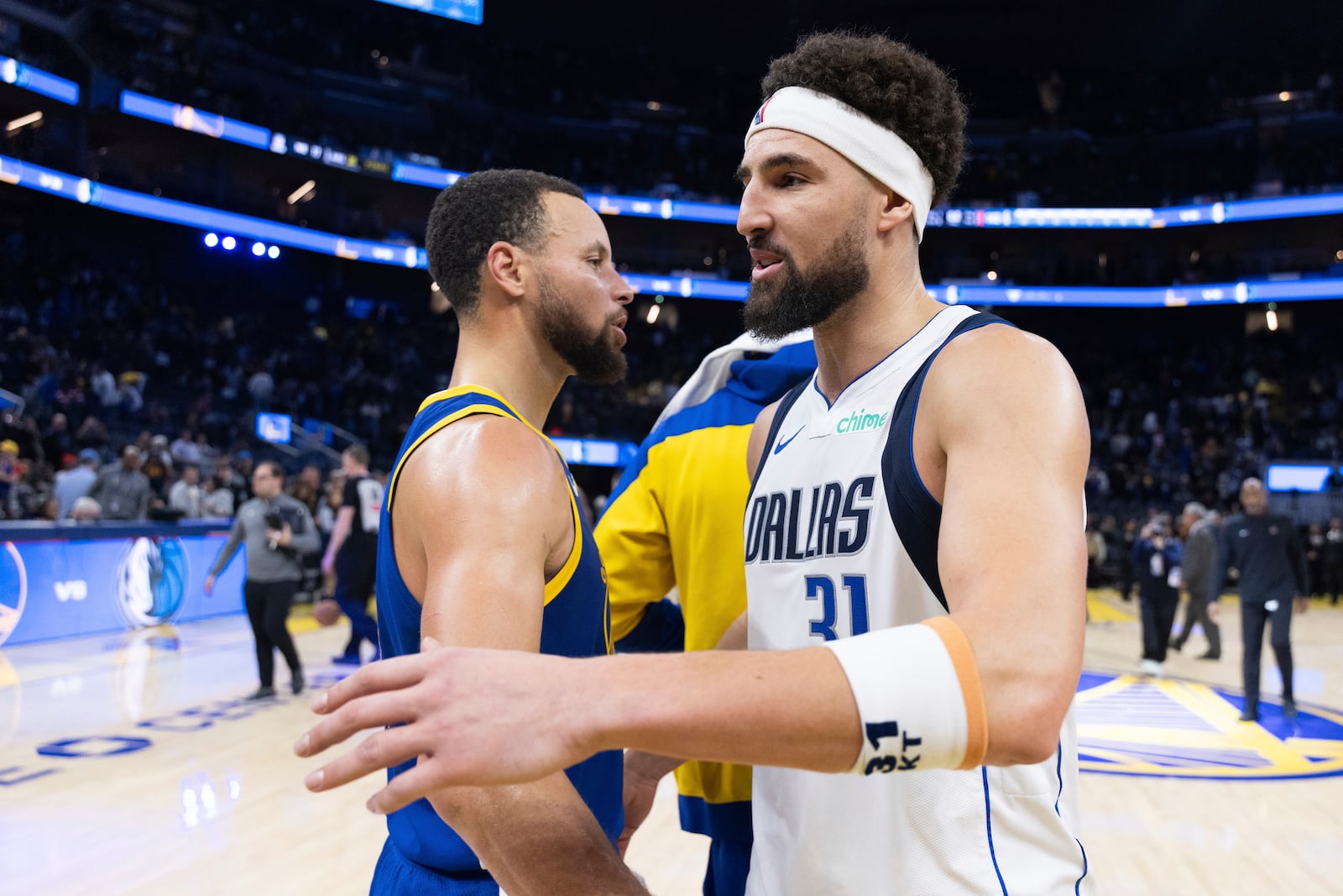 Golden State Warriors guard Stephen Curry interacts with Dallas Mavericks guard Klay Thompson (31) after an NBA basketball game Sunday, Dec. 15, 2024, in San Francisco. (AP Photo/Benjamin Fanjoy)