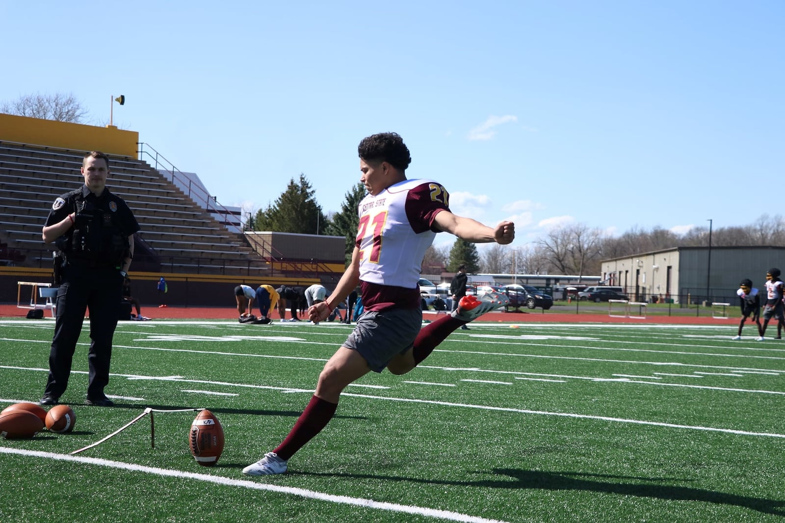 Central State police officer Kole Patterson watches Marauders' kicker Jose Chaires during a recent practice. Central State Athletics photo